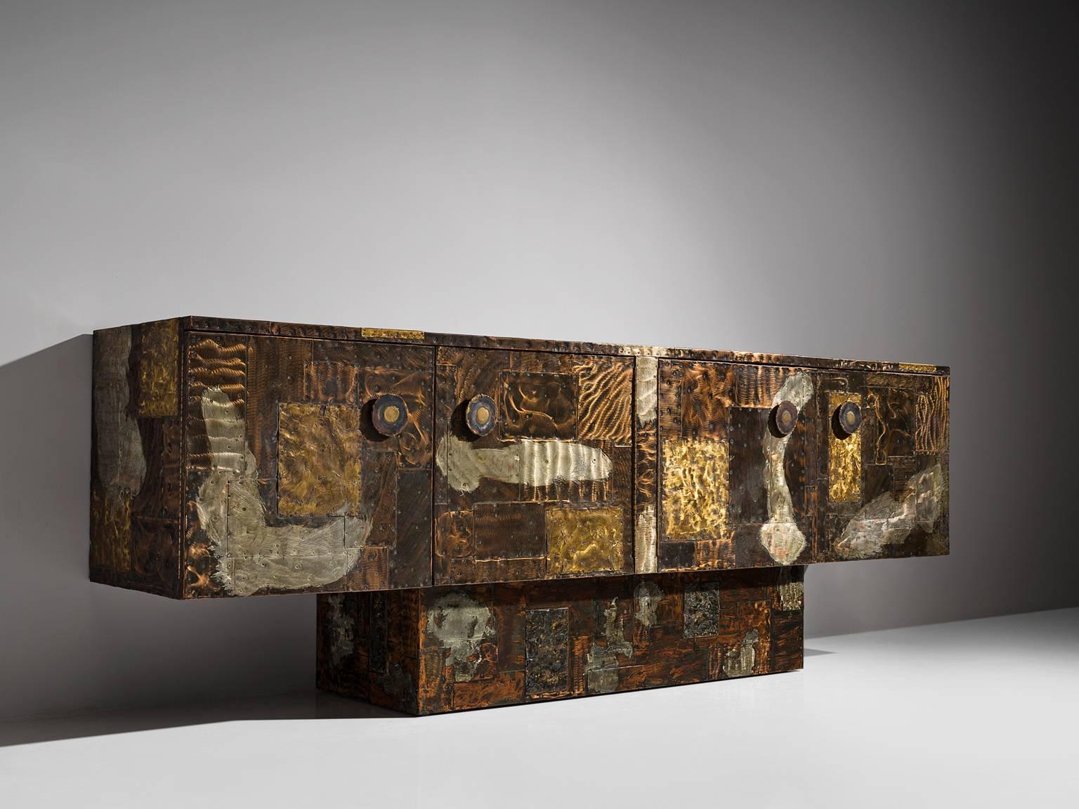 Paul Evans for Directional furniture, Patchwork cabinet, brass, copper, pewter, slate, United States, circa 1968

This pedestal sideboard is designed and produced by Paul Evans. Early in his career, is was already visible that he was interested to