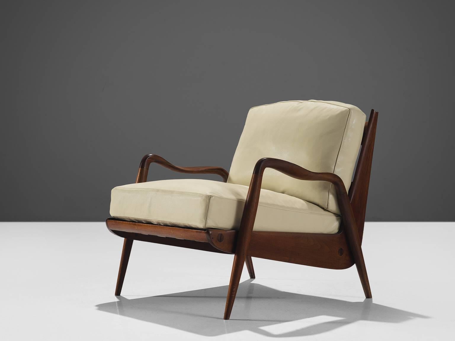 Philip Lloyd Powell, American walnut and beige to white leather, United States, 1960s. 

This sculptural armchair executed in American walnut and leather upholstery is designed by Philip Lloyd Powell. The name 'New Hope' is a reference to the
