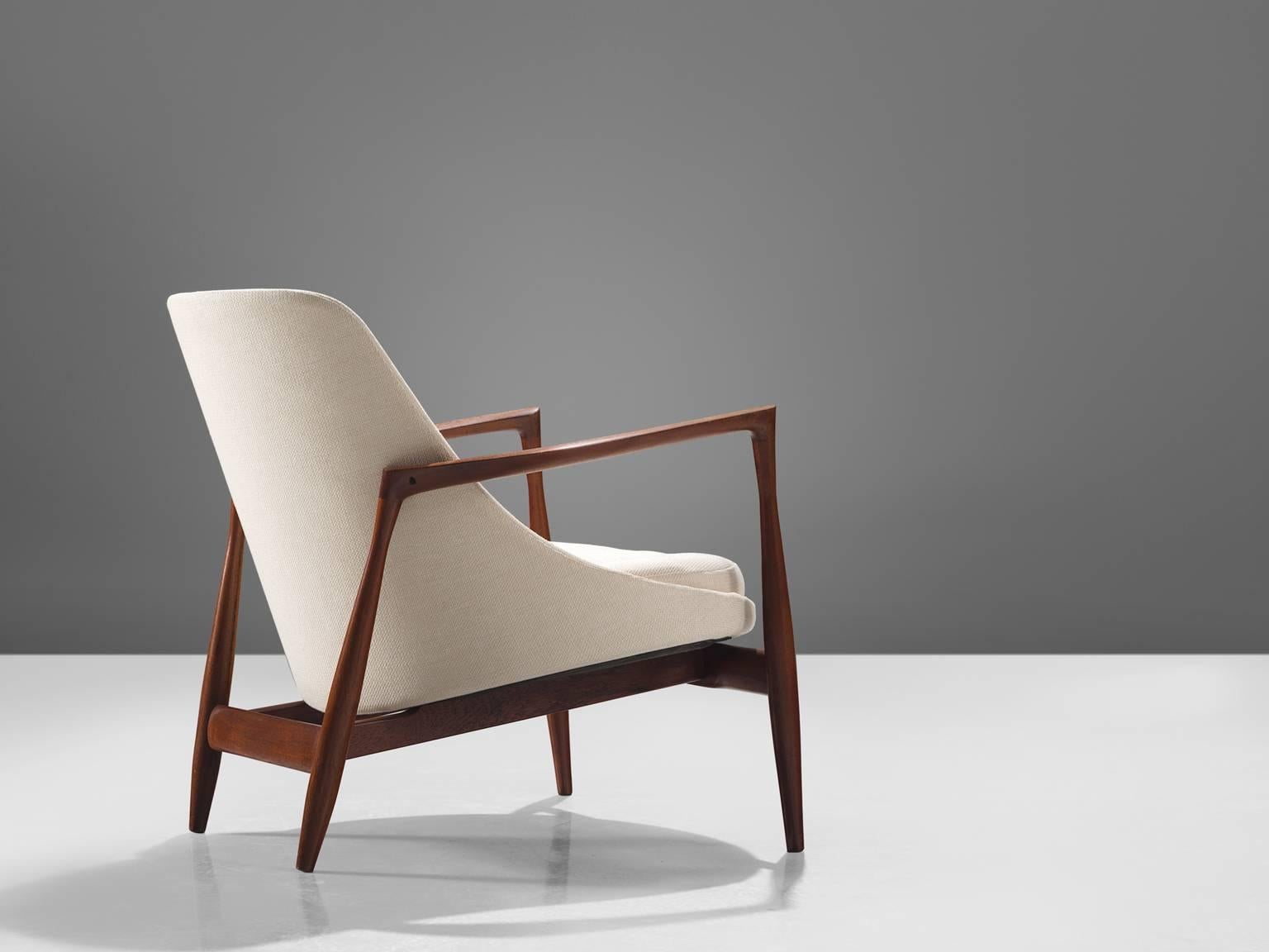 Ib Kofod-Larsen, model U-56 'Elizabeth', teak and white fabric, Denmark, 1956. 

This is Kofod-Larsen's highest-quality armchair. This version is executed with a teak frame and beautiful refined details in the design. This classic chair is one of