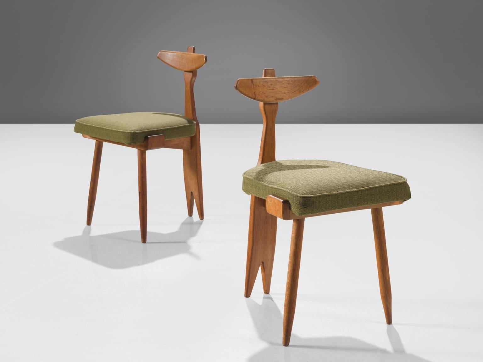 Guillerme et Chambron, oak and green fabric, France, circa 1950

This delicate set of side chairs are executed in in oak and green fabric. This chair displays the characteristic frame of this French designer duo. The chairs feature tapered legs