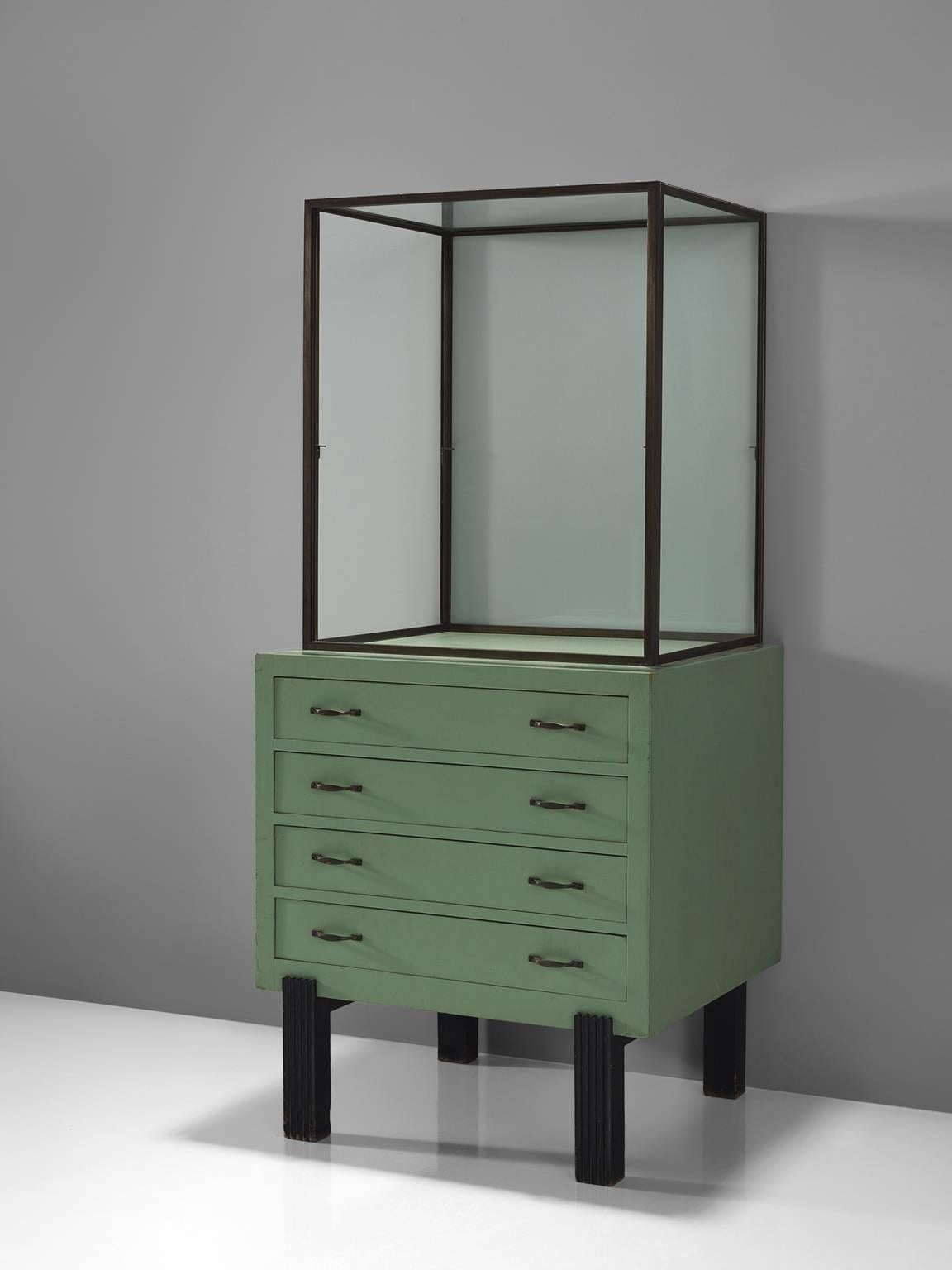 Showcase, metal, wood, glass, Belgium, circa 1940.

Robust midcentury showcase in glass and wood with metal handles. The base of this vitrine is beautifully simply designed as it features four square black feet. The drawers of the bottom cabinet