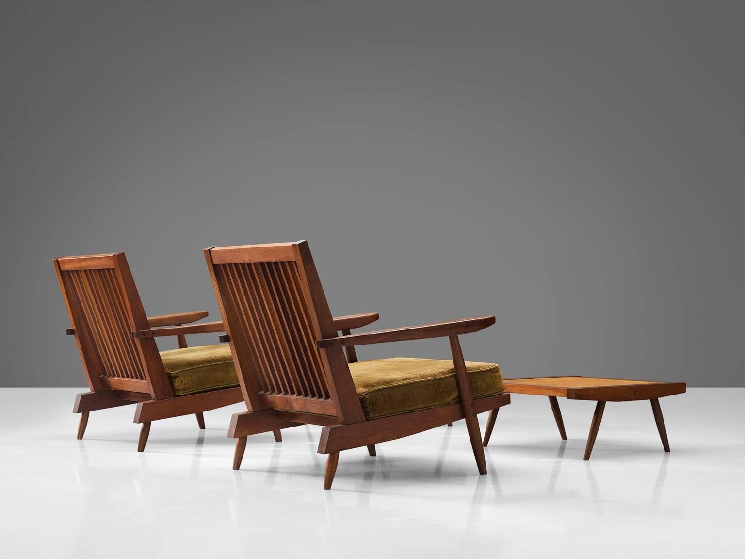 George Nakashima, armchairs, walnut, green to ocre fabric, United States, design ca. 1950

These quintessential spindleback armchairs and ottomans are designed by Nakashima. The chairs feature spindles at the back, referring with this detail to the