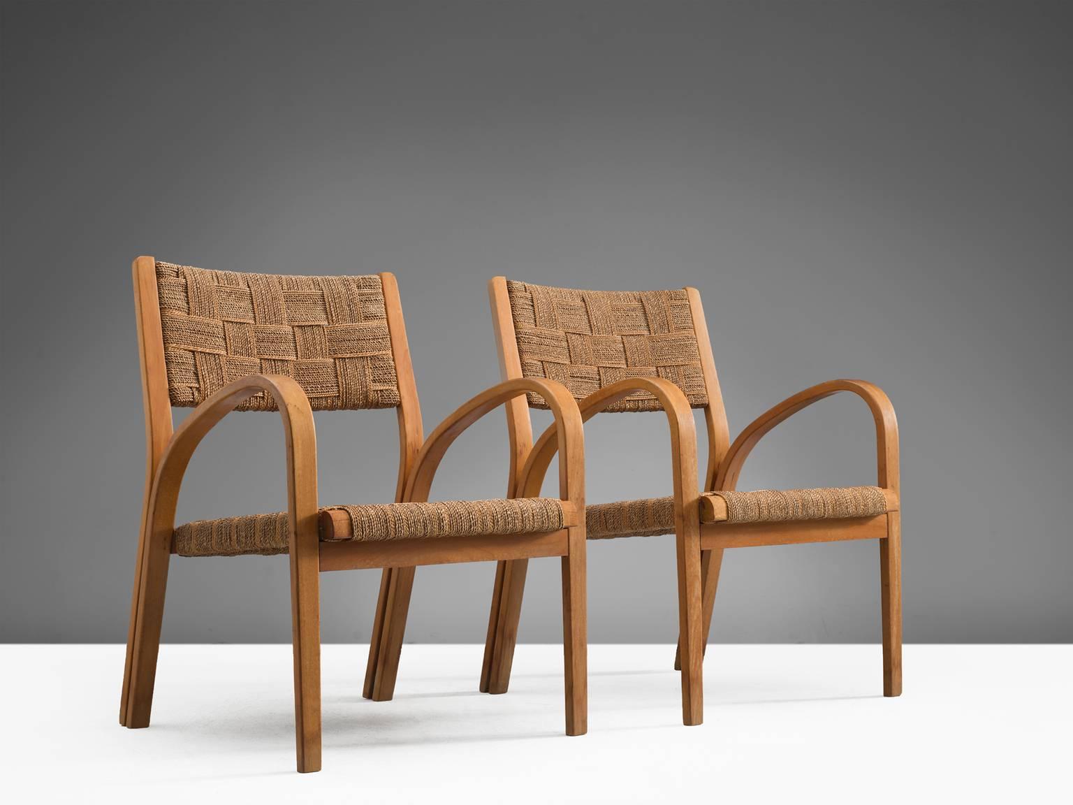 Armchairs with ottomans attributed to Giuseppe Pagano, curved wooden structure coated rope, Italy, 1940s.

These lounge chairs are executed in wood and coated rope. The design of this set of chairs is Minimalist yet not in a Puritan way. The