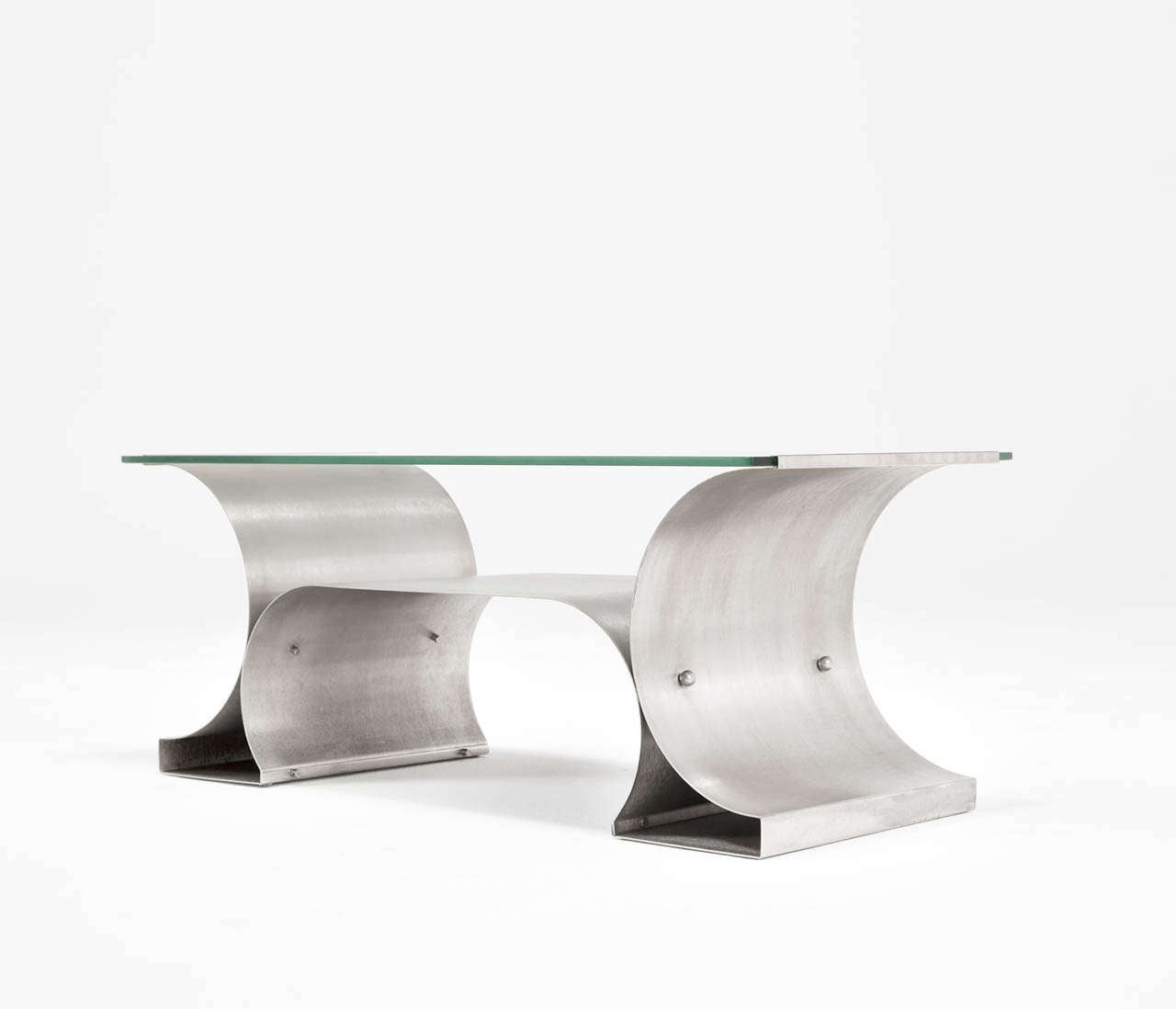 Cocktail table, in stainless steel and glass by Michel Boyer, France, circa 1968.

A stainless steel and glass 'X' series coffee table by Michel Boyer. Parisian designer Michel Boyer is at the forefront of “Modern Classic” design. 
He won renown