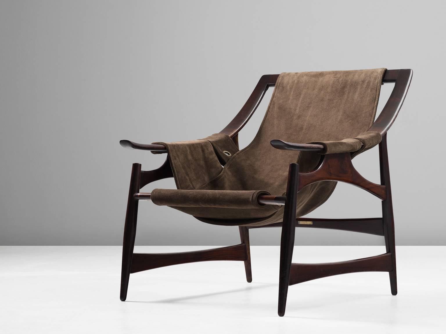 Liceu de Artes e Ofi´cios, lounge chair, rosewood and suede, Brazil, 1960s. 

Beautiful lounge chair in dark Brazilian rosewood with a brown suede upholstery. The frame is a sort of wooden skeleton. An open character with beautiful lines and