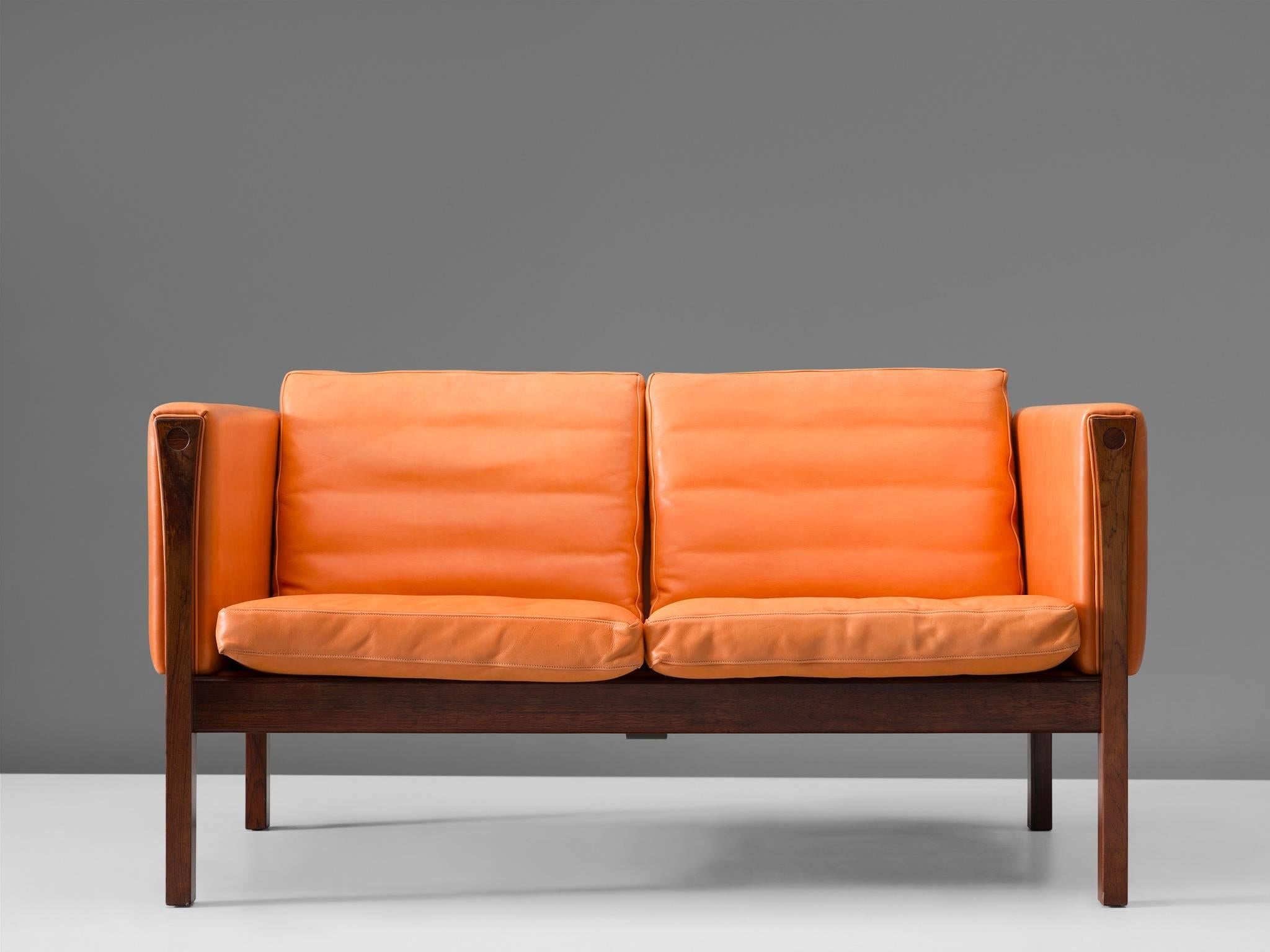Settee, rosewood and leather by Hans Wegner, Denmark, 1965, early production form it's first manufacturer.

This model AP-63-2 by Hans Wegner is a seemingly simple design. Yet with this sofa, Wegner has designed a flawlessly constructed and above
