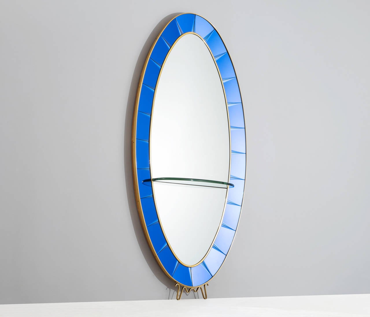 Cristal Art, mirror, blue glass, Italy, 1950s

The mirror is surrounded by beveled blue glass panels, placed in a gilt brass and wooden frame. The glass panels have been very well executed in typically Cristal Art cobalt blue. The brass frame