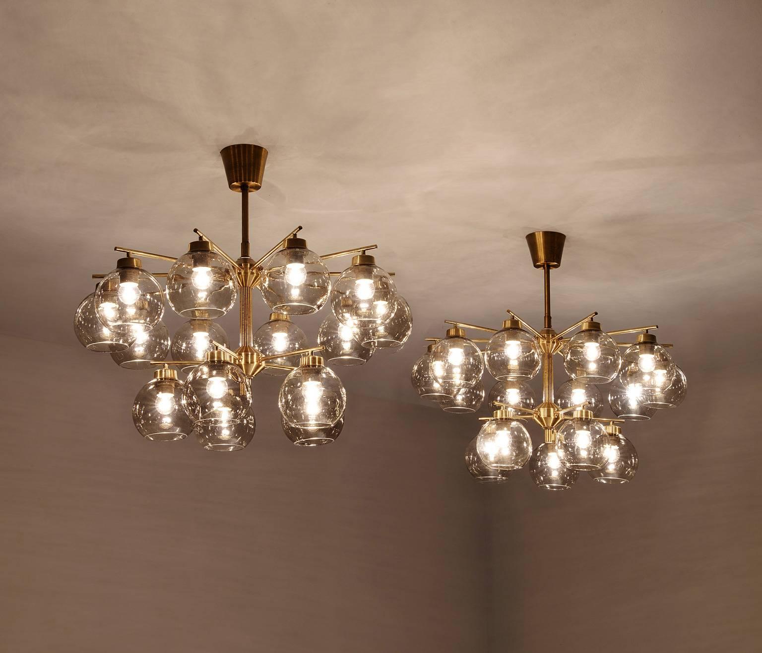 Hans-Agne Jakobsson for AB Markaryd, chandeliers, brass and glass, by Sweden, 1960s.

Swedish brass chandeliers with fifteen brass arms with smoked glass spheres. Divided over two levels, the light created by these chandeliers is very pleasant and