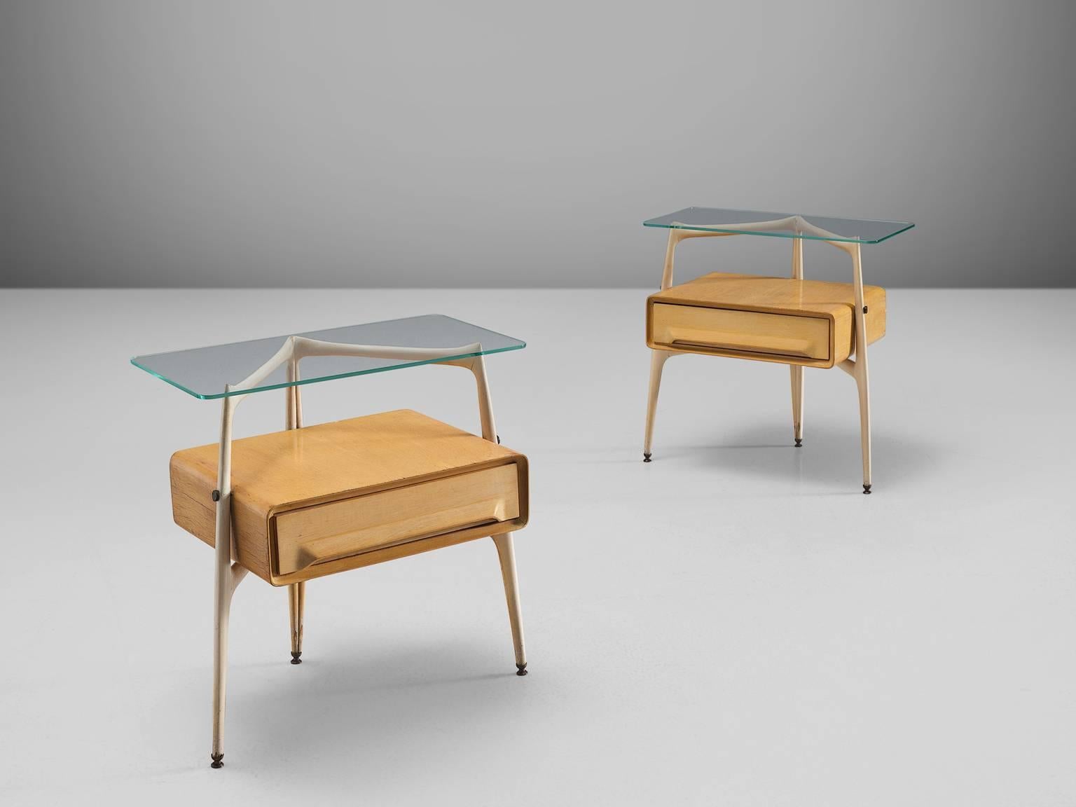Silvio Cavatorta, maple and beech, brass, glass, Italy, 1950s.

These two delicate and sculptural bedside tables are designed by the Italian Silvio Cavatorta. The little maple cabinets feature one drawer each and have a tripod frame. The frame is