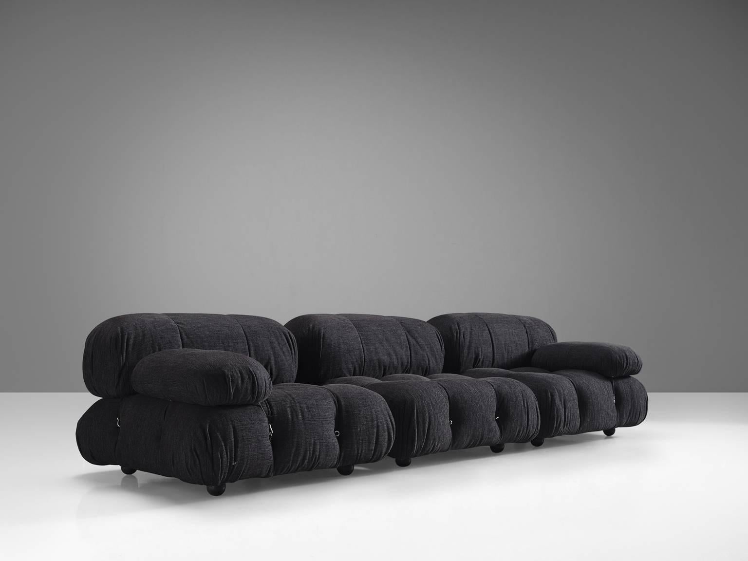 Mario Bellini, modular 'Cameleonda' sofa in dark grey fabric, Italy, 1972.

The sectional elements of this can be used freely and apart from one another. The backs and armrests are provided with rings and carabiners, which allows the user to create