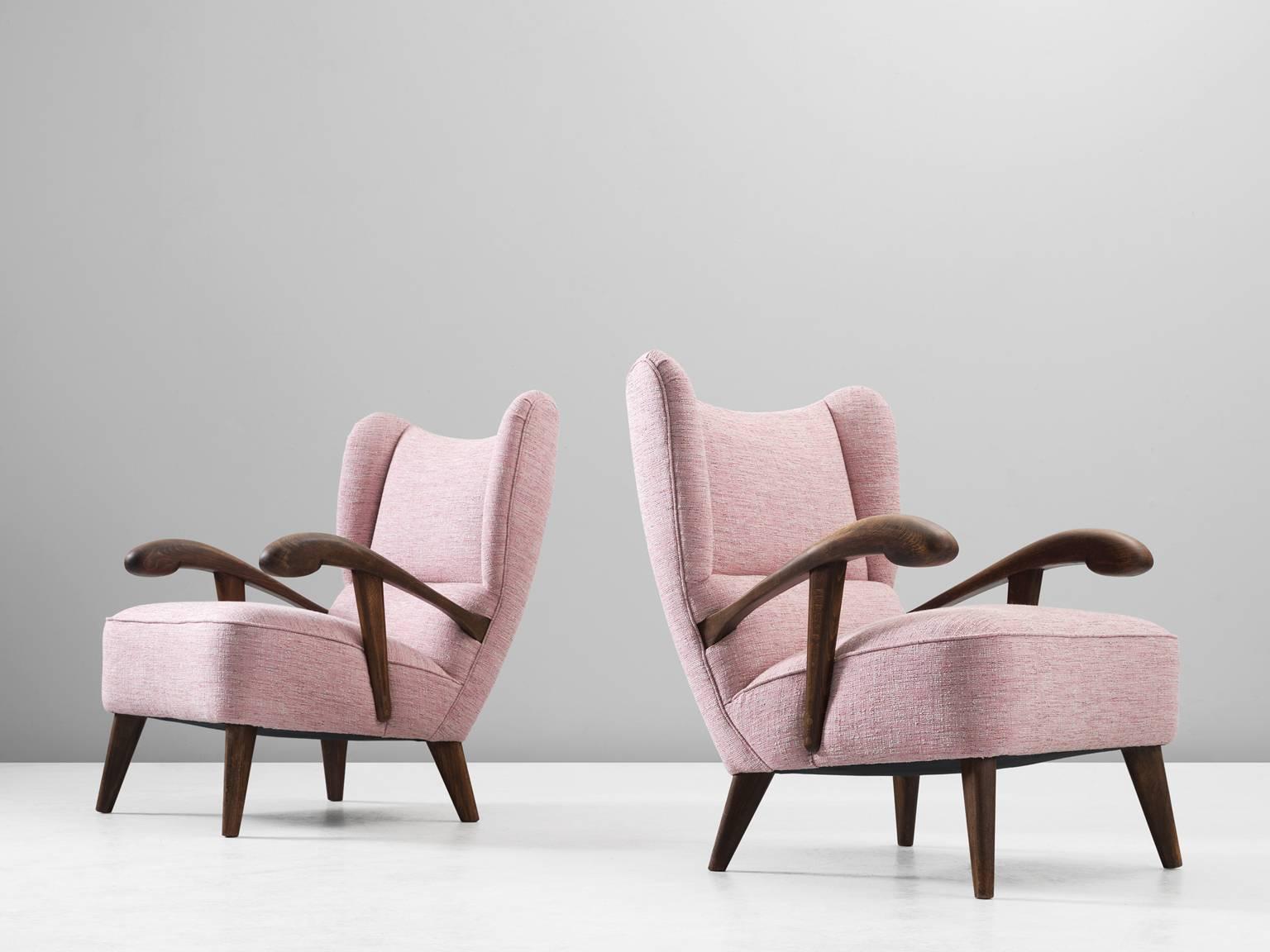 Set of two lounge chairs, in beech and fabric, Czech Republic, 1950s. 

Elegant pair of two wingback chairs with solid beech frame. These armchairs show beautiful lines and curves. The grain of the stained wood is nicely visible, especially on the