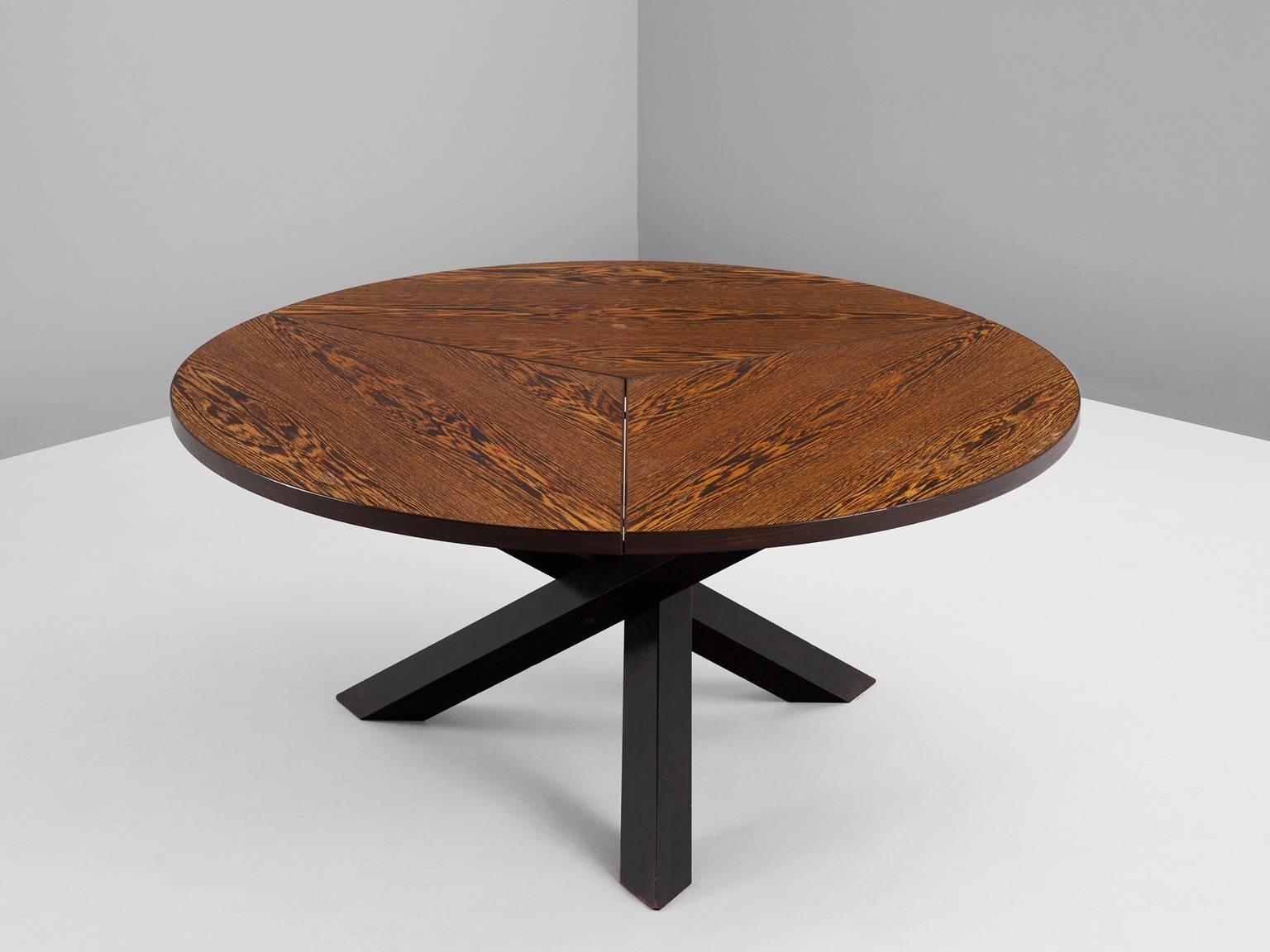Dining table, in Wengé, by Martin Visser for 't Spectrum, the Netherlands, 1960s. 

Beautiful patinated dining table with round top, divided into three parts. The base consist of three crossed legs of solid, dark stained wood. The veneer top