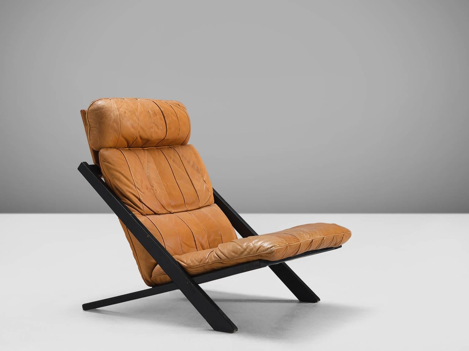 Ueli bergere for De Sede, lounge chair, Switzerland, 1970s.

High back lounge chair by de Swiss quality manufacturer De Sede. The X-shaped frame consists of black lacquered wood. This makes an interesting contrast to the warm patinated cognac brown