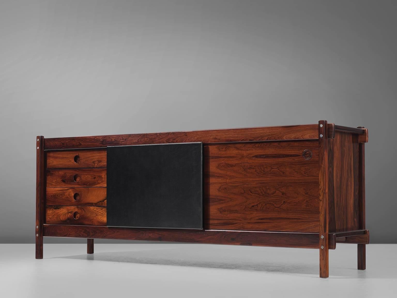 Sergio Rodrigues, buffet, rosewood and leather, Brazil, 1965.

This is a wonderful example of Brazilian modern furniture. Sturdy, warm and of supreme qualities in both material and craftsmanship. This small credenza has four drawers and two