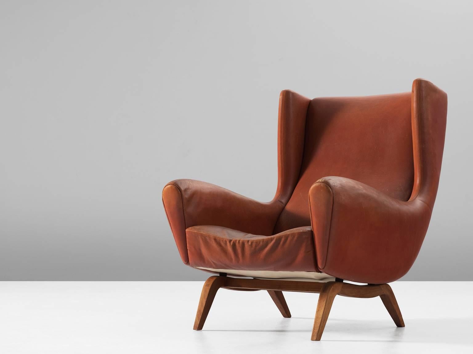 Illum Wikkelsø for Søren Willadsen, lounge chair model 110, leather and teak by Denmark, 1950s.

This well designed armchair shows an unusual elegance and great eye for detail, combined with outstanding craftsmanship, which is characteristic for