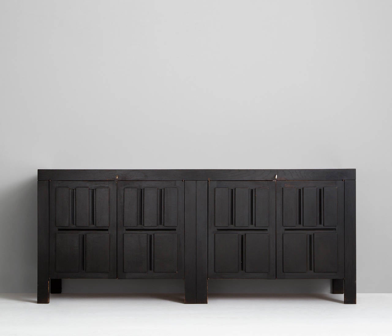 Sideboard, in wood, by De Coene, Belgium, 1970s.

Very well designed graphic credenza with dark brown stained finish designed by de Coene, Belgium. The matte dark brown finish is a perfect combination with the graphing panels because of the high