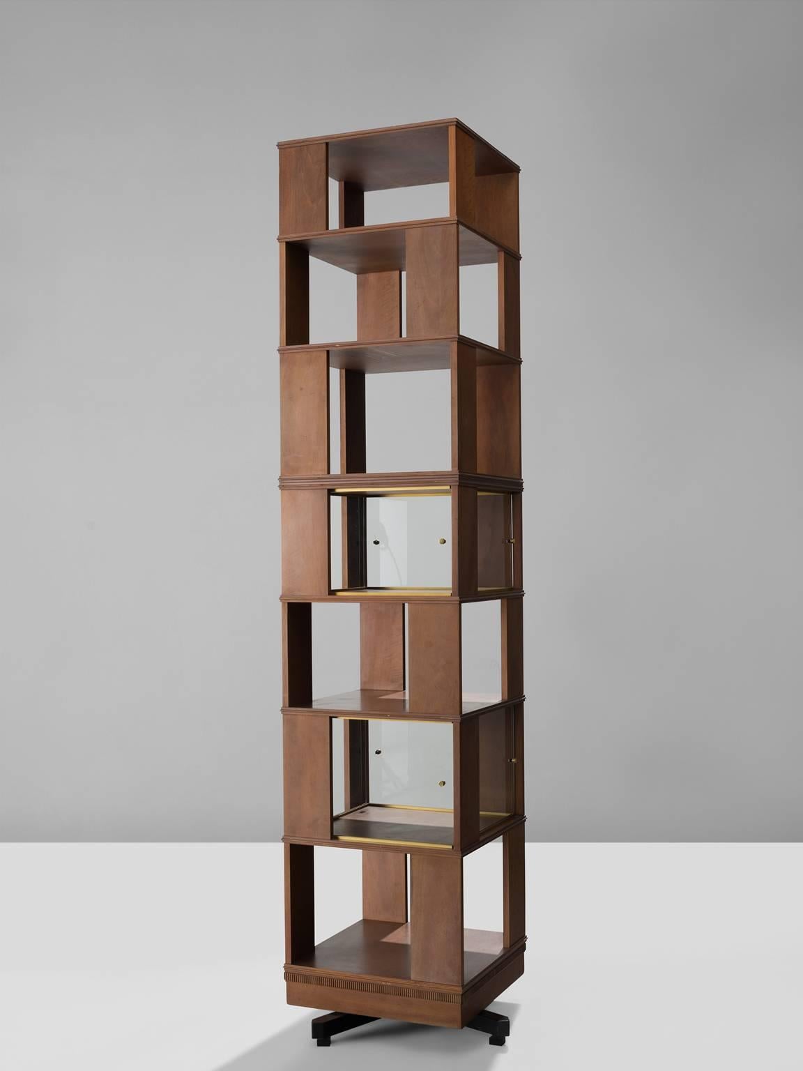 Swivel bookcase, in wood and glass, Italy, 1960s. 

Beautiful tall swivelling bookcase designed in the manner of Claudio Salocchi. This Mid-Century Modern swivelling bookcase features storage divided over seven levels. It holds two integrated