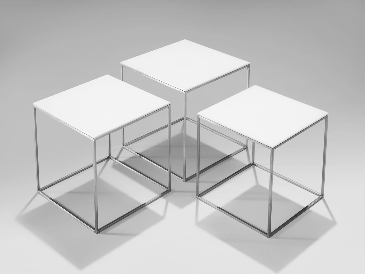 Poul Kjærholm, nesting tables, white acrylic and steel, Denmark, circa 1957.

These modernist Danish nesting tables were manufactured in Denmark by fE. Kold Christensen. They feature a chrome frame, with a white acrylic slick top and an open