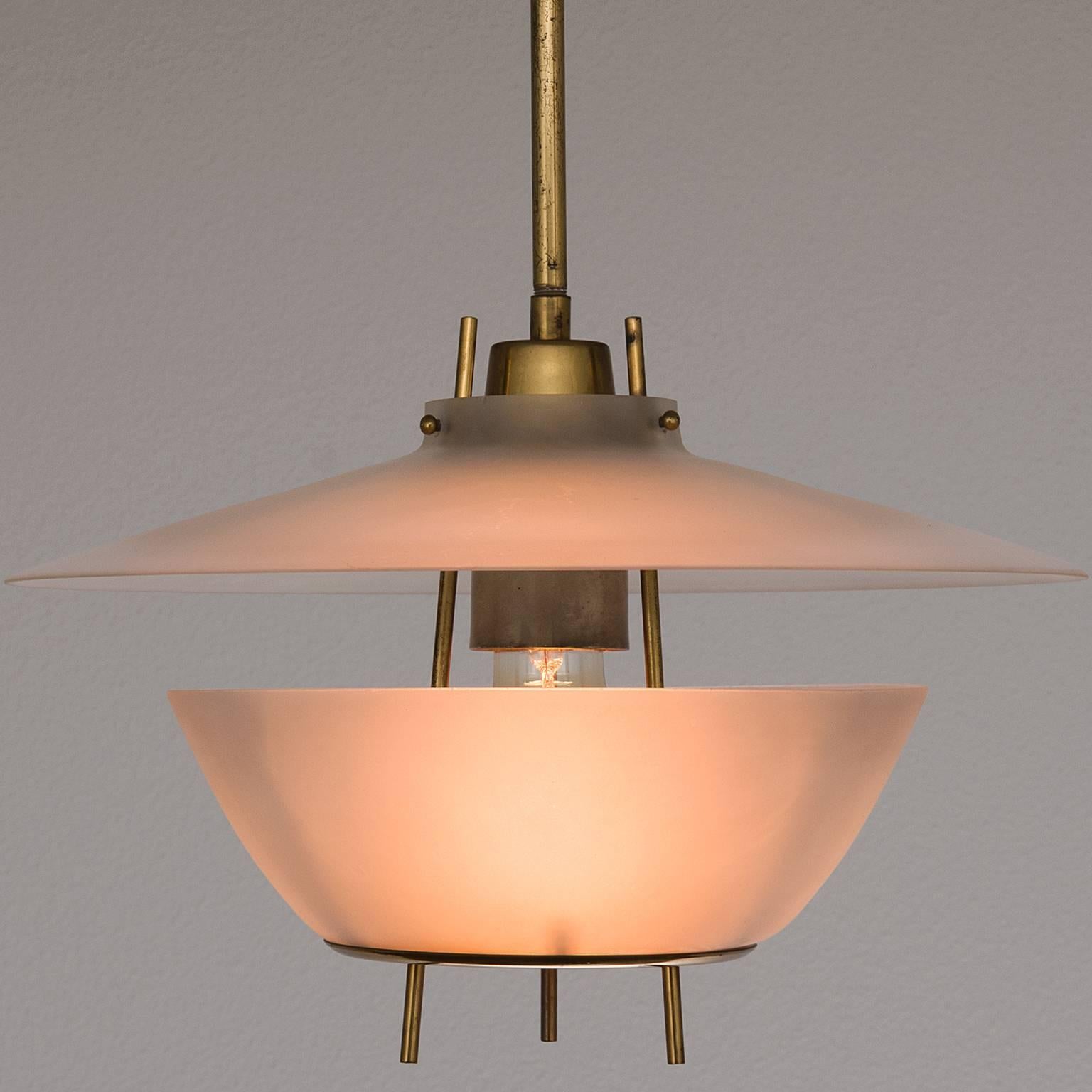 Pair of elegant pendants in brass and Lucite. Designed and manufactured by O-Luce, Italy, 1960s.

These pendants have wonderful mounting elements in brass, they show the high standard of quality and detail O-Luce is known for. The elegant shades
