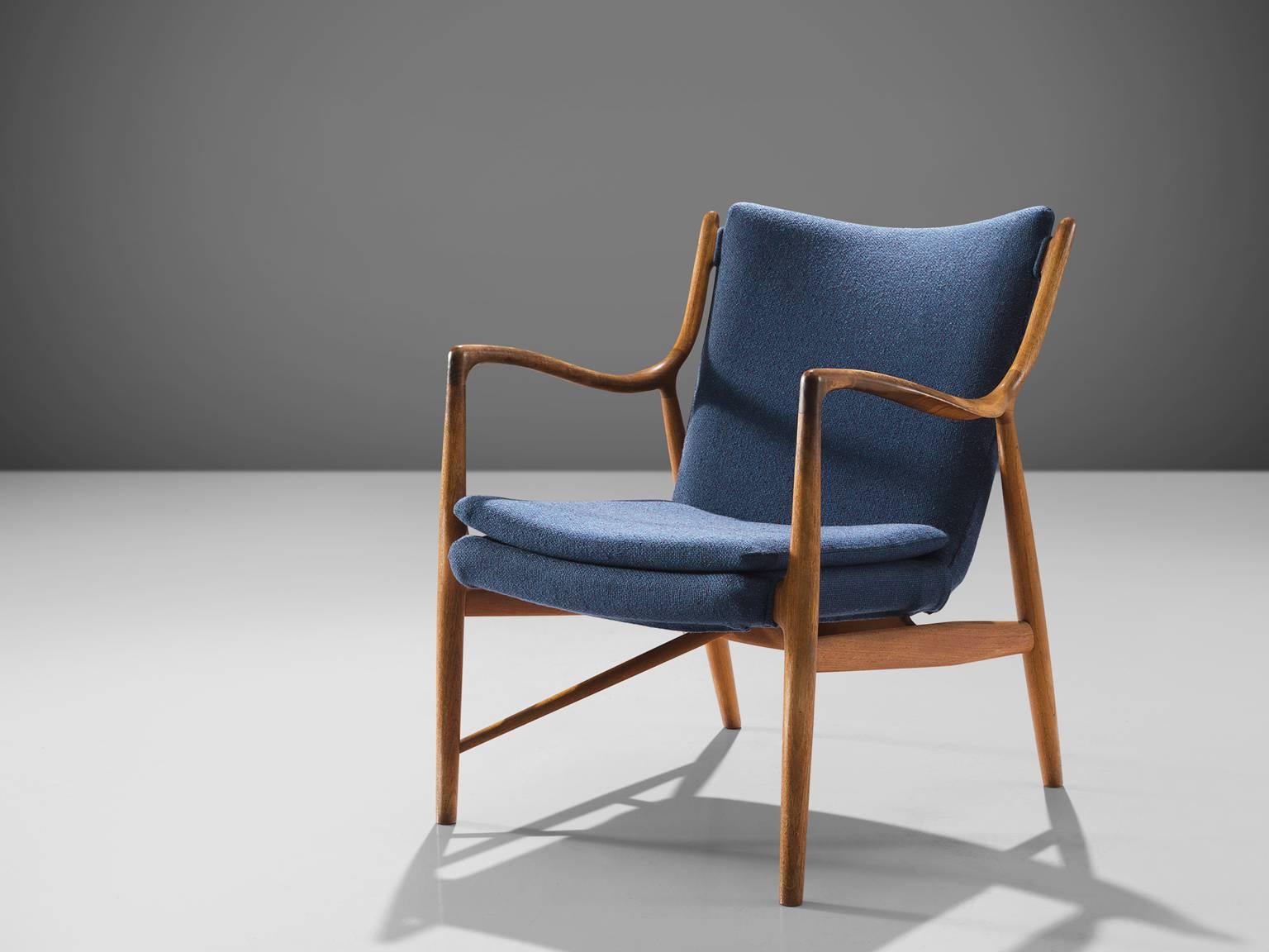 Finn Juhl for Niels Vodder, NV45, teak and fabric, Denmark, design 1945, production 1950s. 

This NV45 chair by Finn Juhl and Niels Vodder is executed in teak and blue fabric. The chair is made by master woodworker Niels Vodder and is marked on