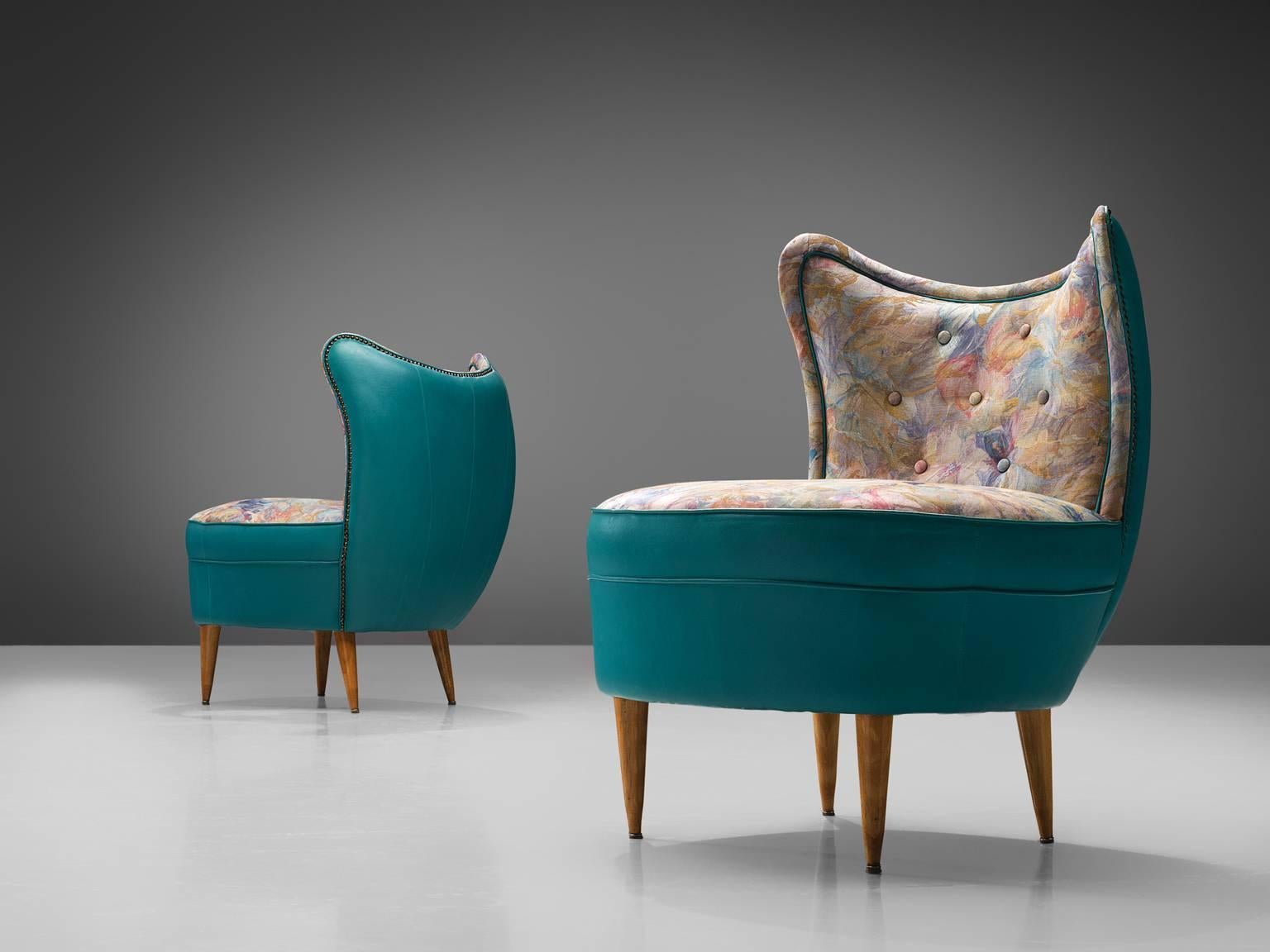 Sofa, turquoise leatherette, fabric, wood, Italy, 1950s.

This set of easy chairs show traits of the design by the Italian designer Veronesi. The quirky set is elegant and frivolous and is completely rounded when seen from behind. The pieces feature