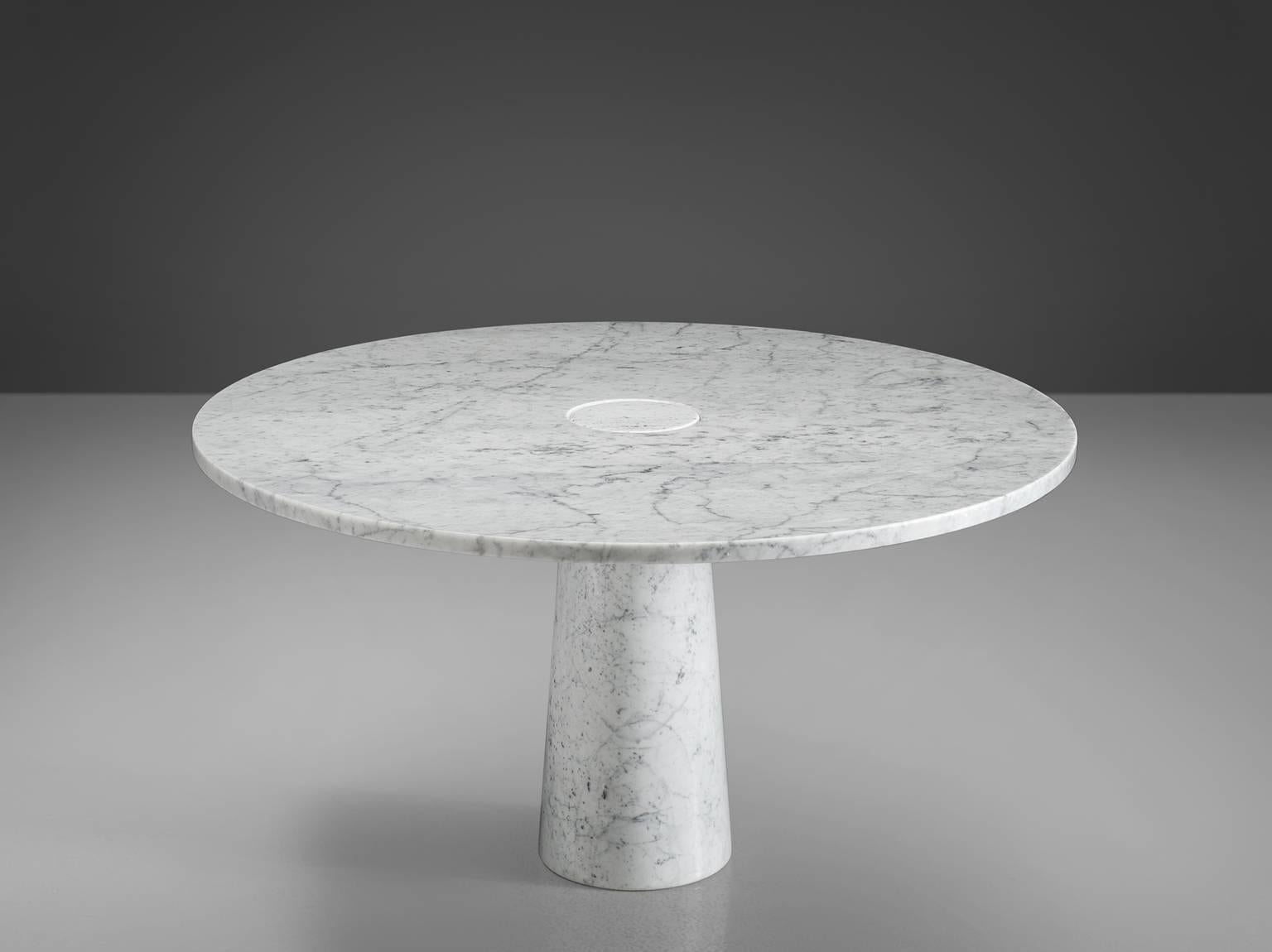 Dining table, marble, Italy, 1970s. 

This architectural table is a skillful example of postmodern design. The circular table features no joints or clamps and is architectural in its structure featuring one single column that is attached to the