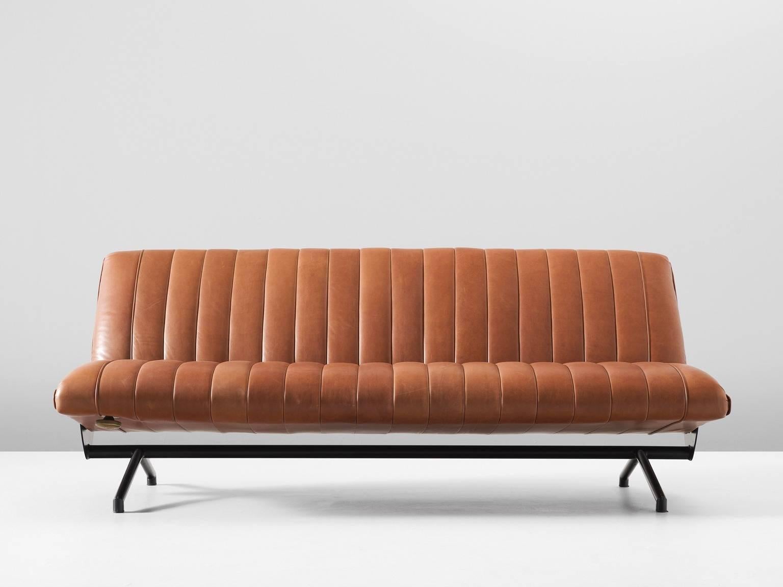 Osvaldo Borsani for Tecno, sofa model D70, in cognac leather, metal and brass, Italy, 1954. 

This iconic sofa by Italian designer Osvaldo Borsani is reupholstered in high-quality brown leather. The vertical stripes of the leather seating remind