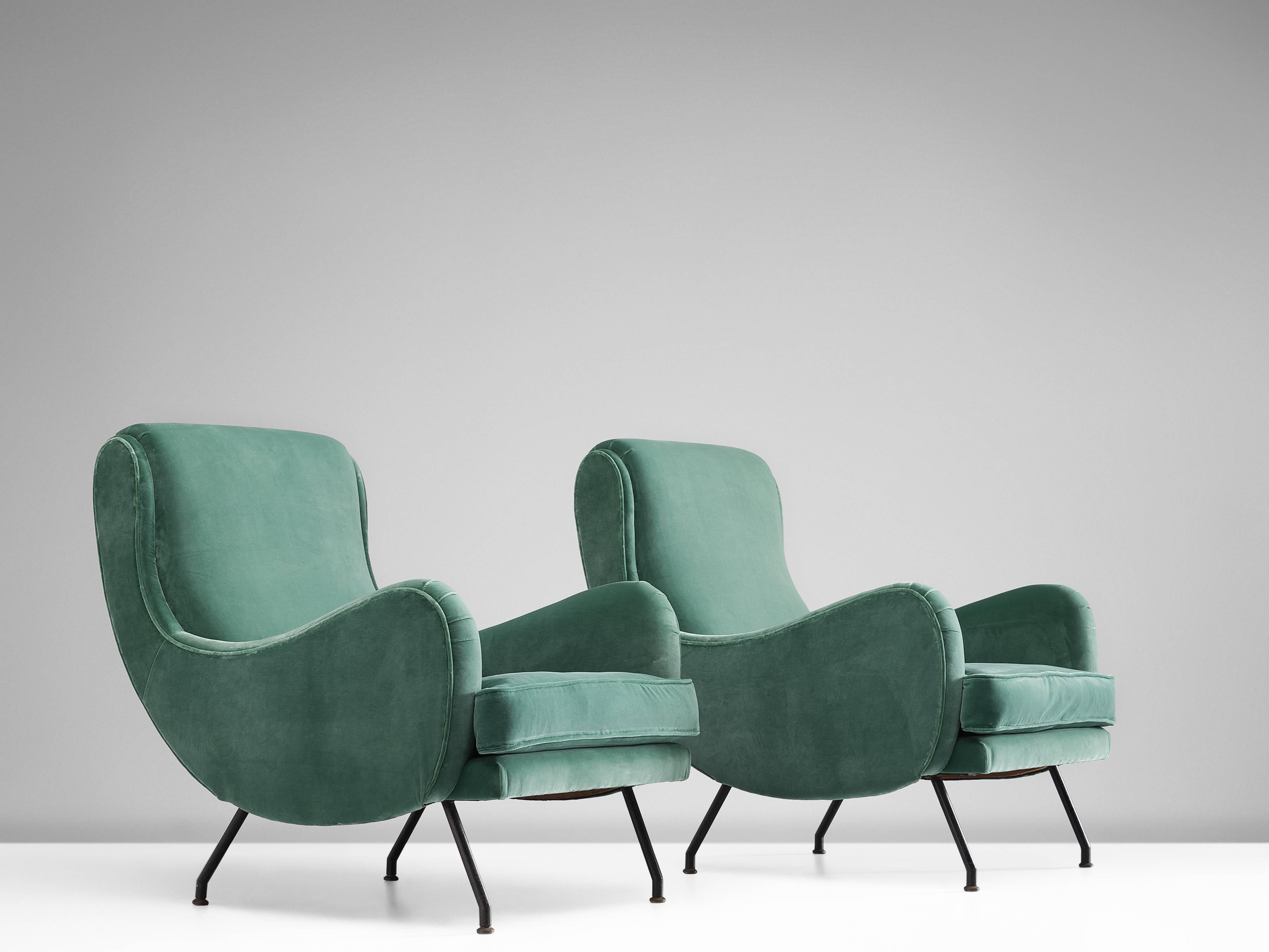 Pair of easy chairs, green velvet and metal, France, 1950s.

These well-made armchairs show a great deal of craftsmanship. The chair features a large, tilted comfortable seat with wing like armrests and a tilted back for comfort. The green soft