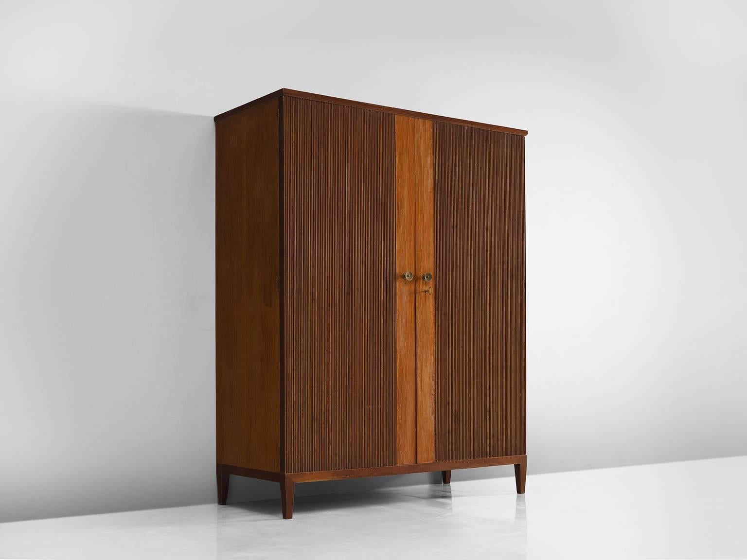 Set of cabinets, oak, brass, Europe, 1950s.

This set of two oak cabinets is are simplistic yet refined. The details are what make this midcentury chest stand out. The front is carved and shows a ribbed oak stained from. The middle section of the
