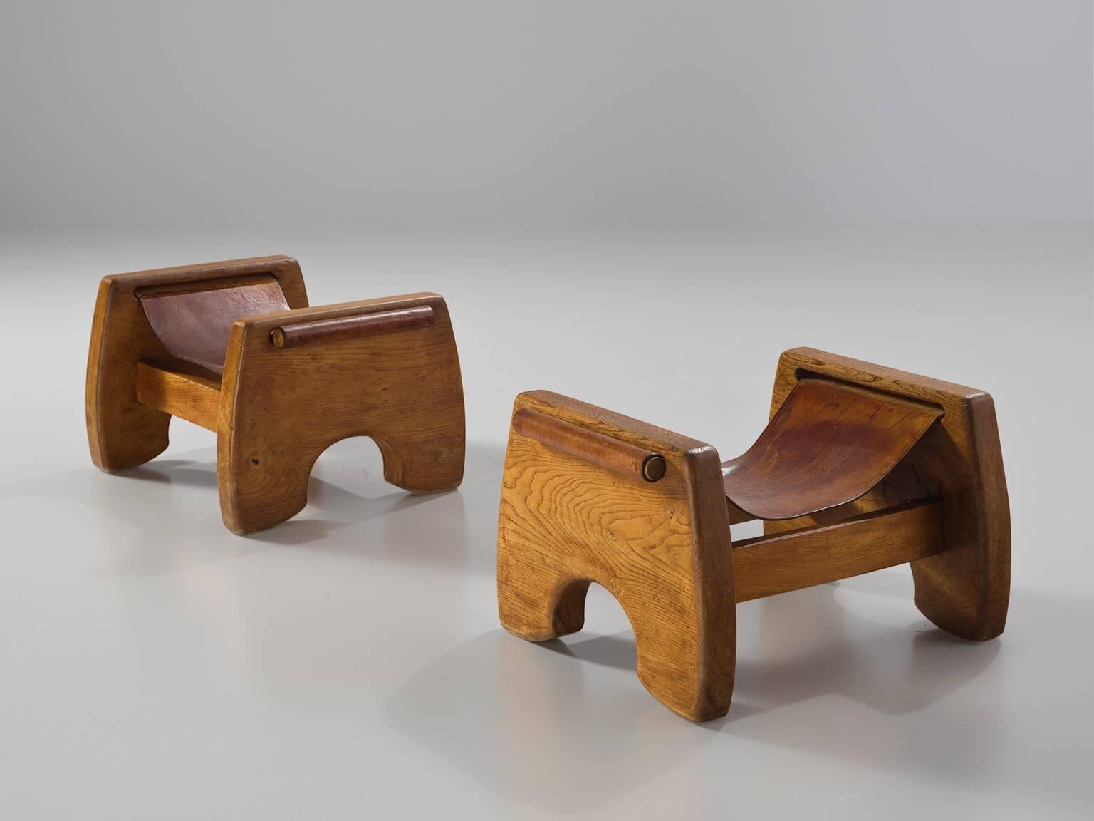 Stools, oak and cognac leather, France, 1940s

This robust and rustic set of stools draws its strength from both the strong design and the use of natural, sturdy materials. The sculptural, dense ook frame consists of two U-shaped sides and