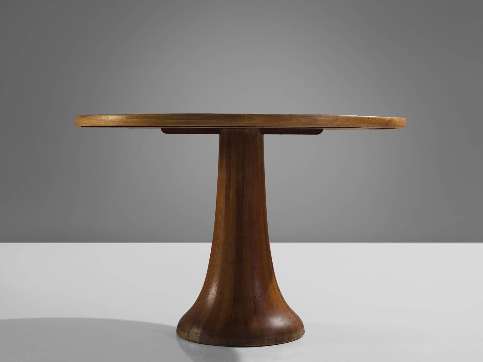 Centre table, oak, Italy, 1970s.

This strong, graphic circular dining table features a colon foot and a thick circular inlaid oak tabletop. Both the top and the foot are created by means of putting together strips of oak, creating an abstract