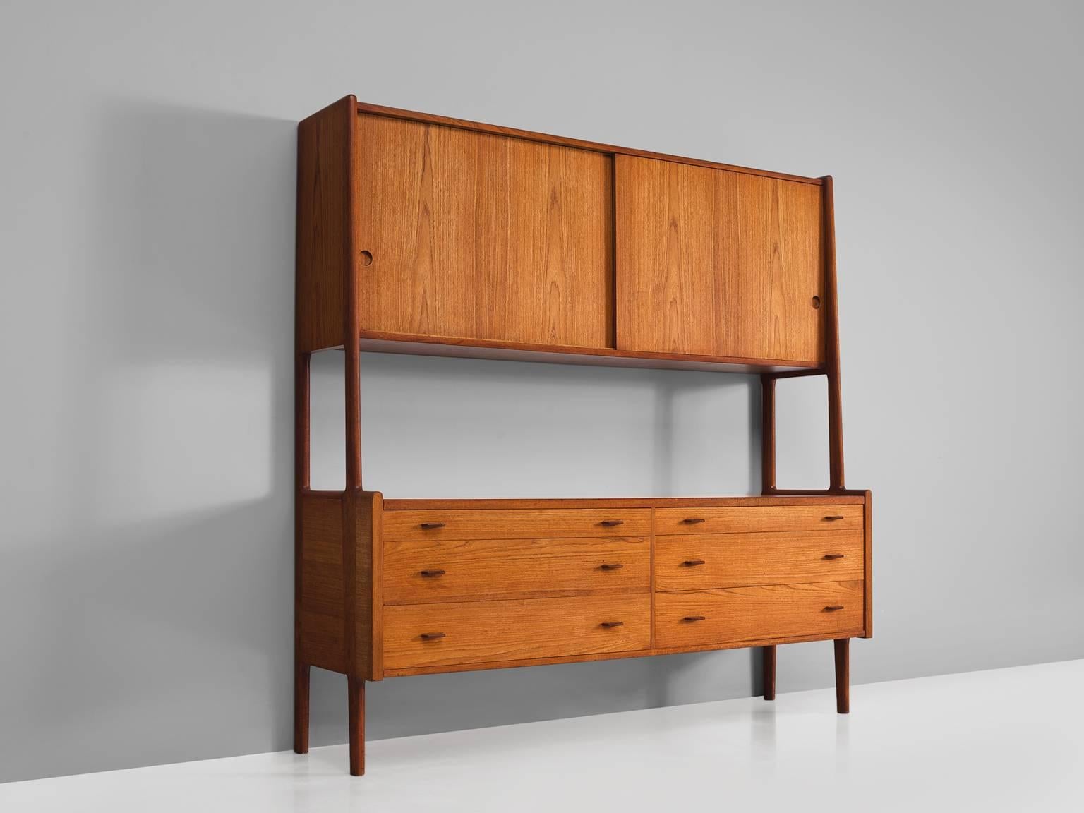 Hans Wegner for Ry Møbler, cabinet RY20, teak, Denmark, 1950s.

This cabinet is executed in teak and is typical for midcentury Scandinavian design. The cabinet features a base with four cylindrical legs that function as connective elements for the
