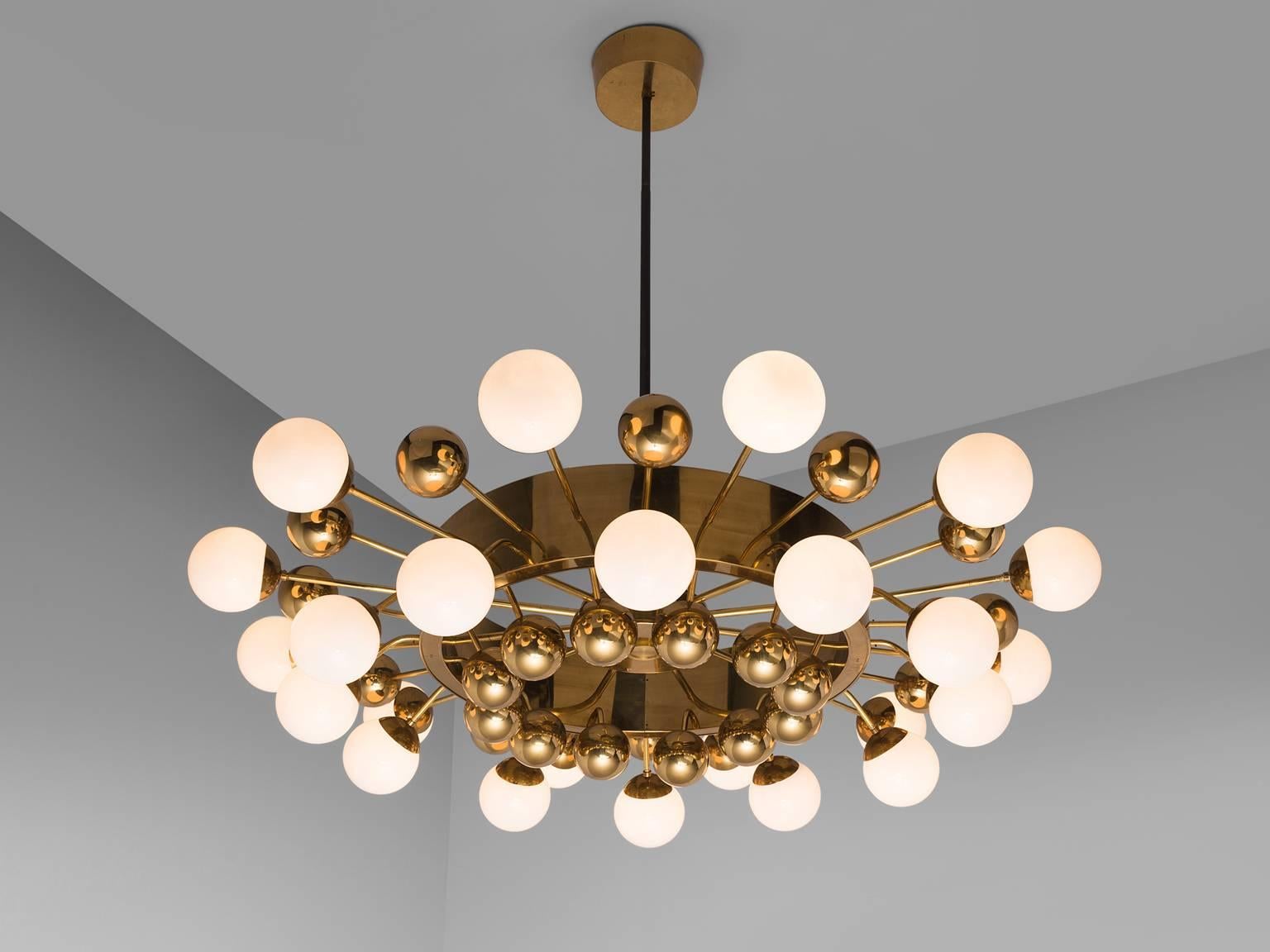 Large Sputnik chandelier in glass and brass, Europe, 1960s.

This Sputnik chandelier is a wonderful example of midcentury design. The grand chandelier is executed with a brass fixture and opaline glass spheres. The chandelier exists of two layers