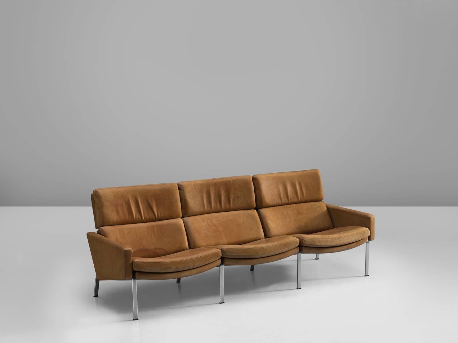 Jørgen Kastholm for Alfred Kill, three-seat sofa, leather and steel, 1970s.

This lovely cognac three-seat sofa with six steel legs is very comfortable. The soft patinated cognac leather cushions provide the back with excellent support. The sofa