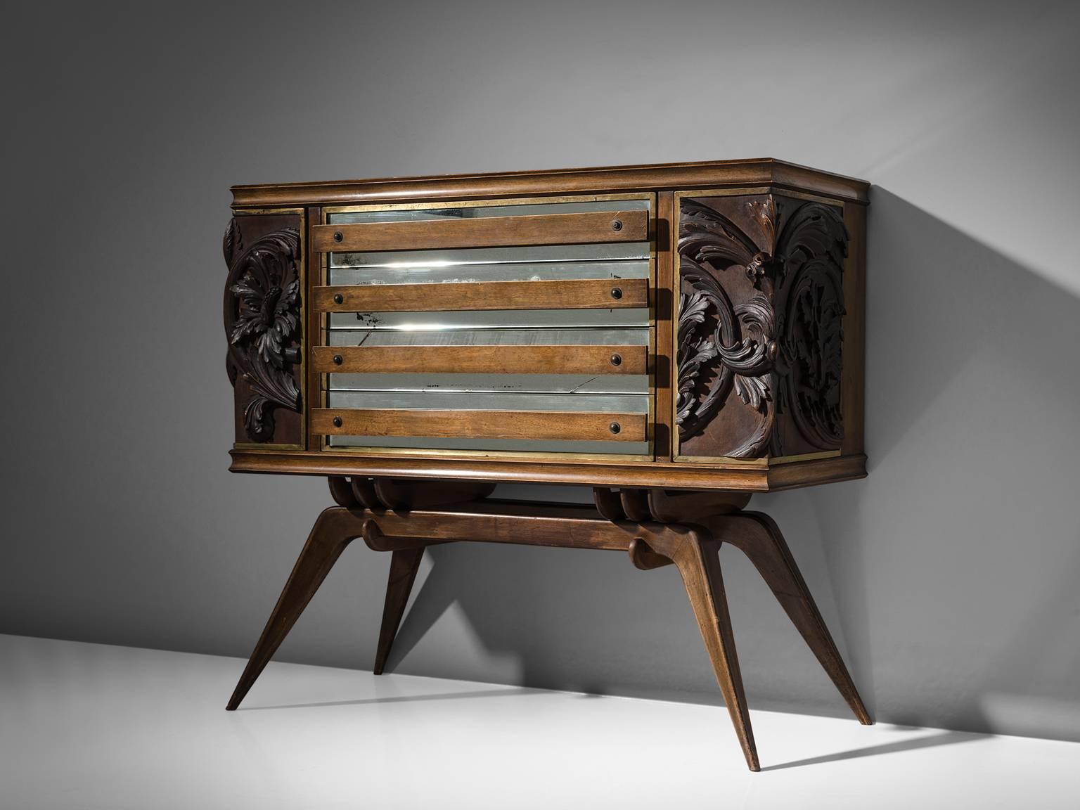 Sideboard, oak, marble, mirror, Italy, 1940s.

The two outer door panels of this cabinet show a very interesting carved oak pattern of floral natural wooden elements, which give this sideboard an expressive touch.
Behind the carvings storage