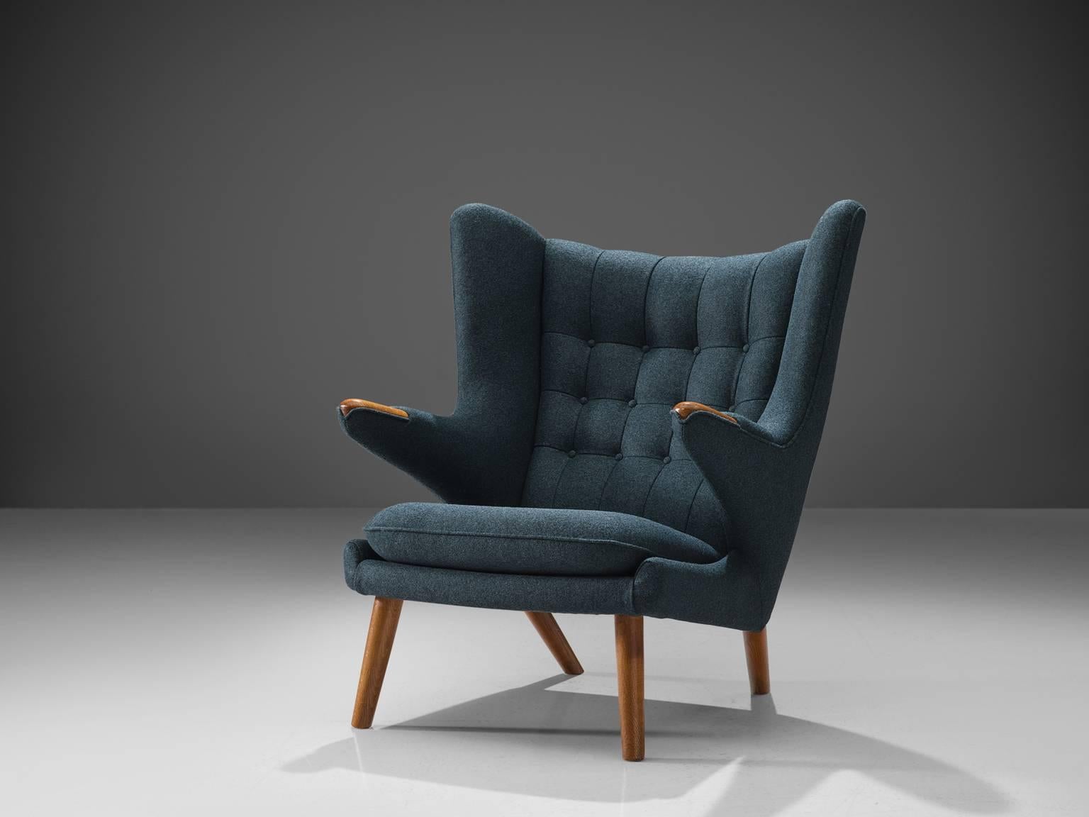 Hans J. Wegner by AP Stolen, lounge chair Model AP 19 'Papa Bear, Denmark, 1951 design, production late 1950s, blue fabric reupholstery.

This semi-wingback armchair, has an open expression in contrast with its historical ancestors. Wegner made a