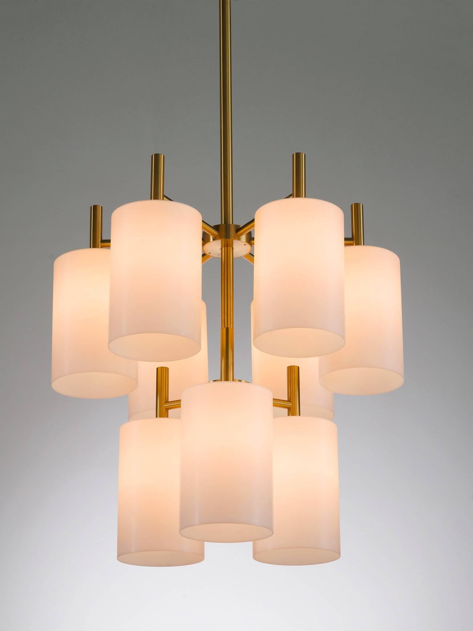 Pendants with nine cylindric white Lucite and brass, Luxus, Sweden, 1960s.

This chandelier is made of brass and the tall stem with nine branches that all end with a downwards facing cone. The symmetry and geometric form of make this a very