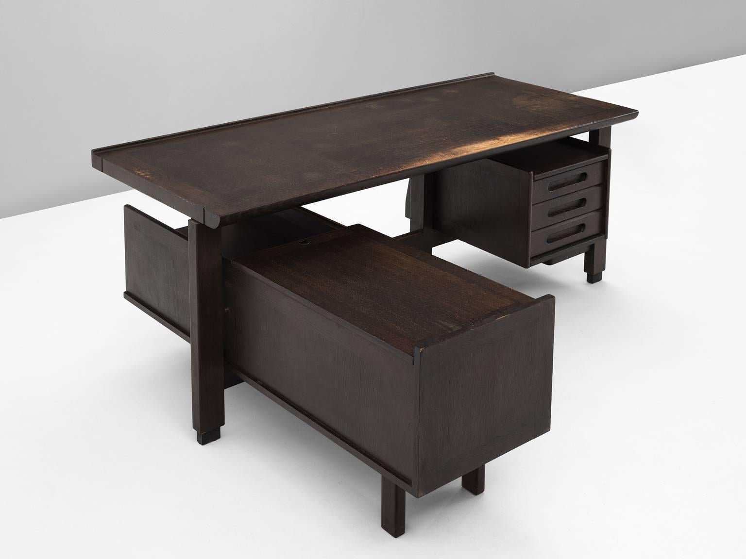 Corner desk in stained oak, by Guillerme et Chambron, France, 1960s. 

Corner desk by French designer duo Guillerme and Chambron. This executive desk shows the fine craftsmanship and line work that characterizes the work of this designer duo. The