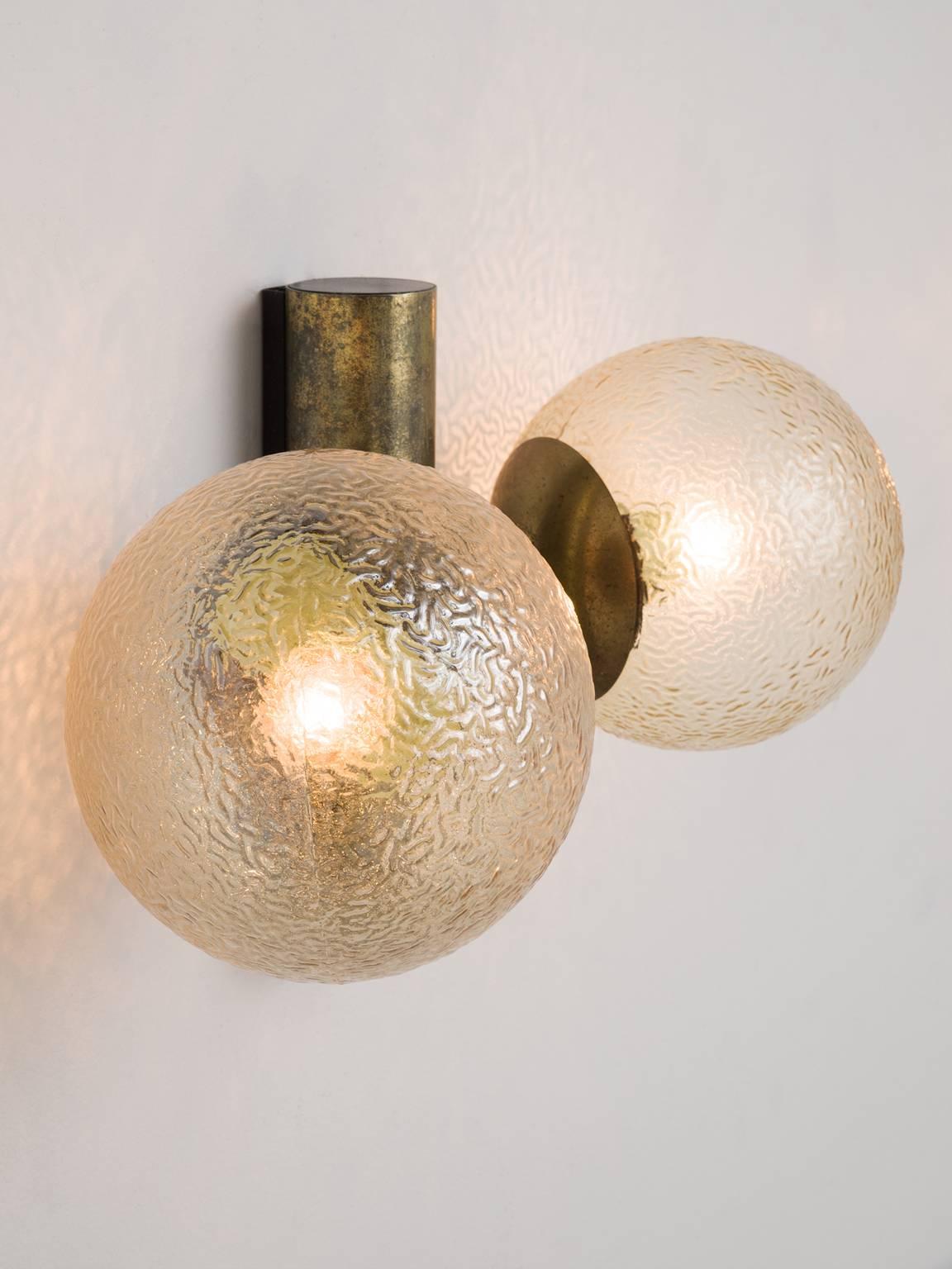 Set of two wall lights, in metal and structured glass, Europe, 1970s.

Set of 2 wall lights. These lights have a simplistic design. It's strength is in the combination of the forms and materials. The fixture is a large tube, two large globe shaped