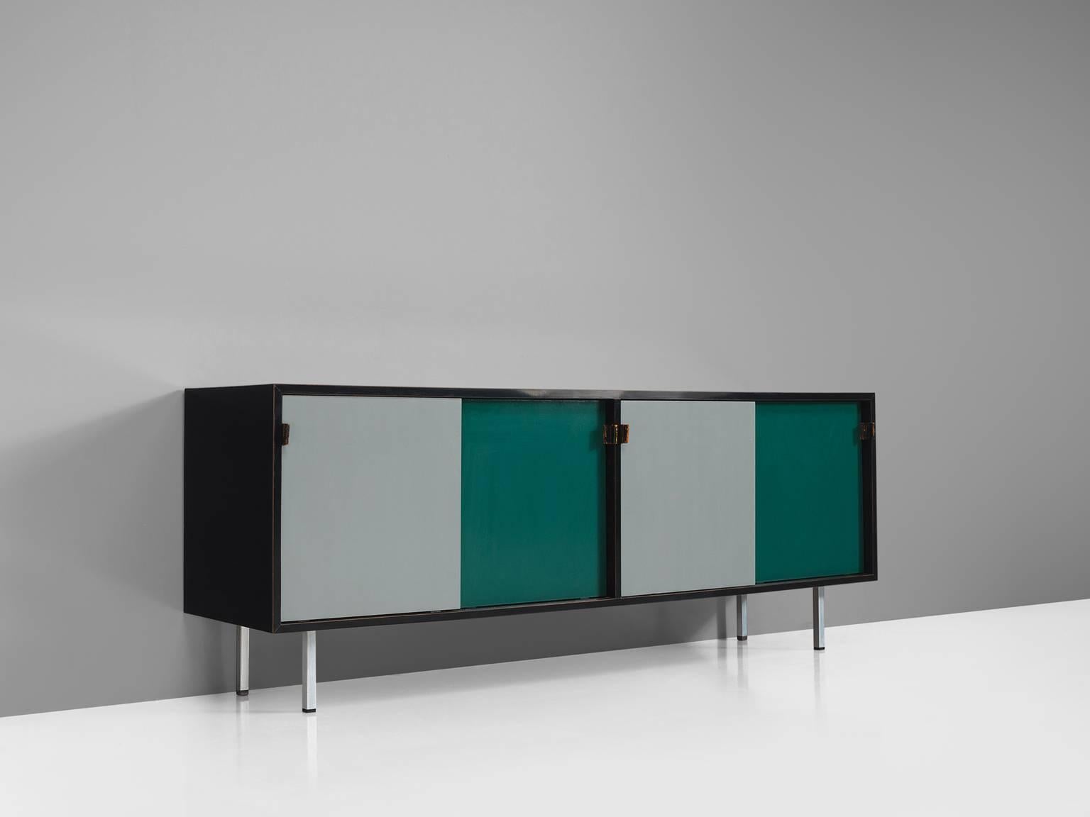 Florence Knoll for Knoll, sideboard, grey and green wood, metal feet, leather straps, France, 1960s.

This sideboard is designed and made by making use of color blocks. The sideboard is executed in green and grey sliding doors that are framed by a