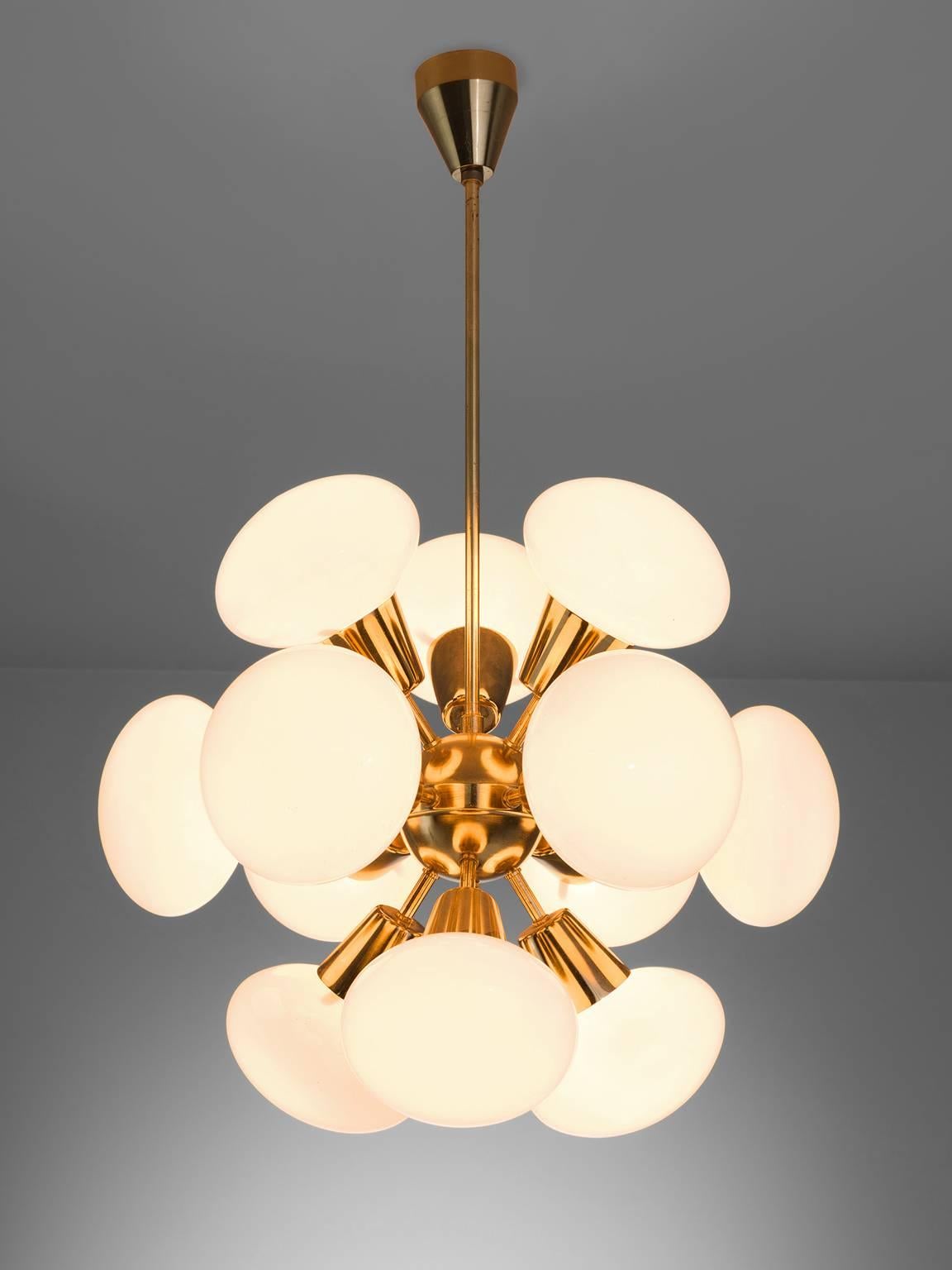 Sputnik chandelier, in brass and opaline glass, Europe, 1970s. 

This small Sputnik features twelve rare 'flat' spheres. Each chandelier consist of a brass fixture with 12 arms, all with an opal sphere. The frosted glass these lights create have a