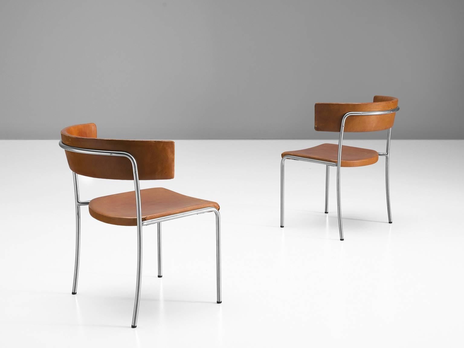 Set of dining chairs by Erik Karstrom, cognac to orange leather and metal, produced in Sweden, 1965.

These exceptional and rare chairs are designed for the Civic Hall Orebro, built in 1957-1965, which was designed by the architect Erik & Tora