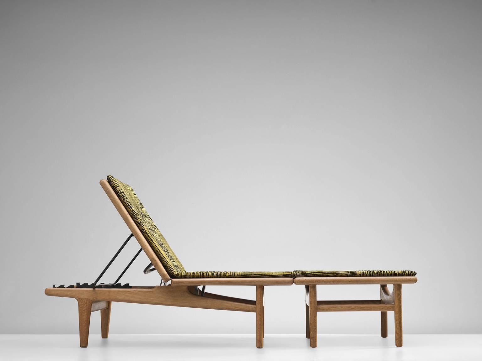 Chaise Longue with ottoman GE01, in oak, metal and fabric, by Hans J. Wegner for Getama, Denmark, 1954. 

The chaise consists out of two sections. An adjustable lounge chair and an ottoman which can be combined into a daybed. This daybed is a