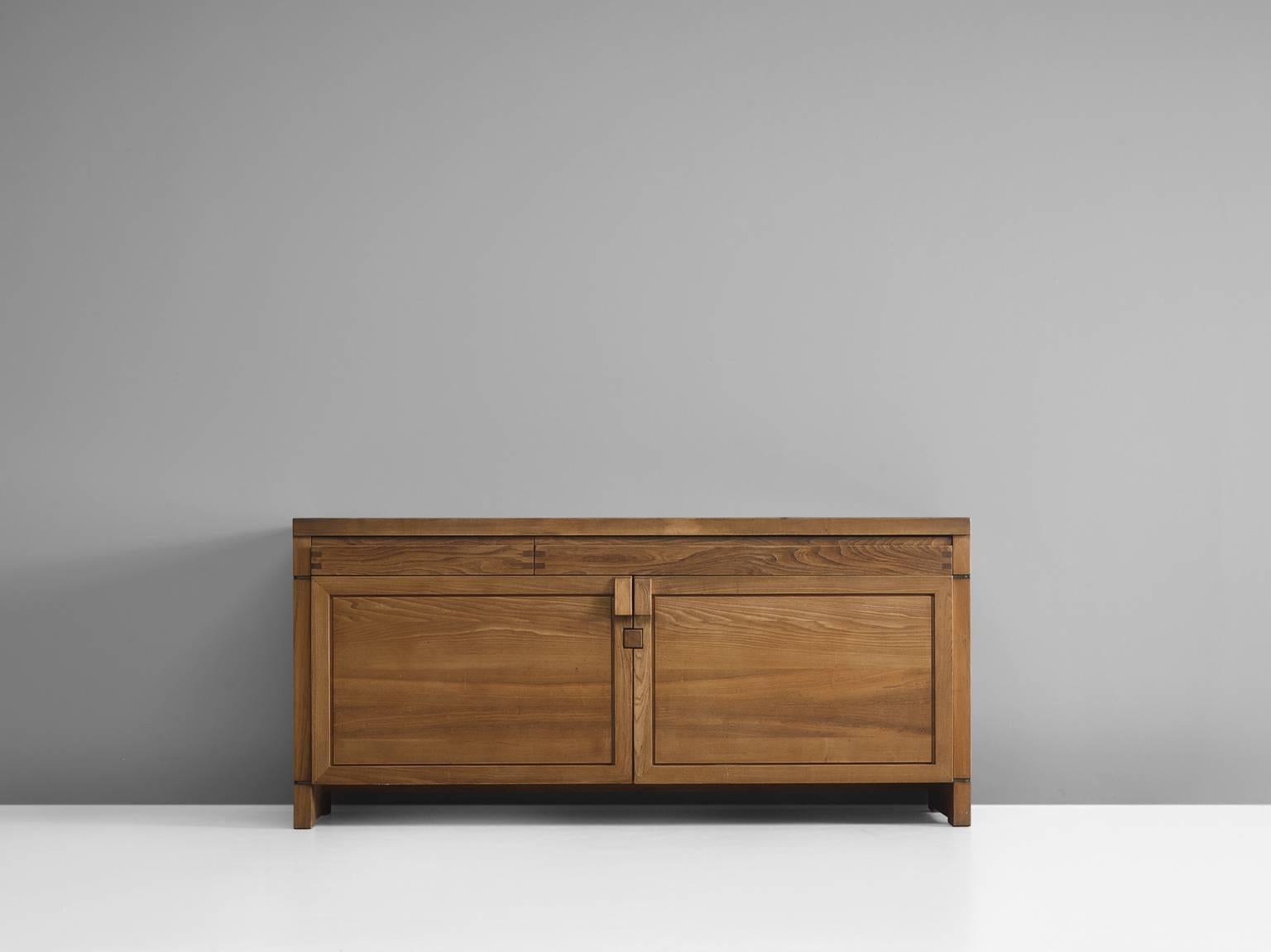 Pierre Chapo, sideboard, Model R08, elm, France, circa 1964.

This exquisitely crafted credenza combines a simplified yet complex design combined with nifty, solid construction details that characterize Chapo's work. The well proportioned doors
