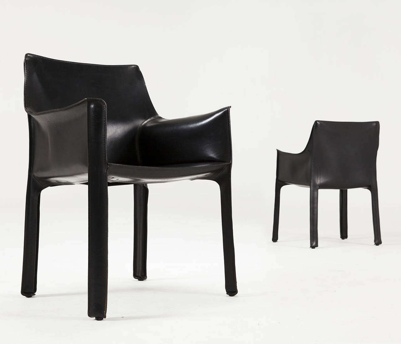 Mario Bellini for Cassina, Pair of CAB 415 armchairs, metal and black leather, Italy, 1987.

These armchairs designed by Mario Bellini in the 1980s. Conceptually, the chair was designed to become marked and shaped over time by its user. The