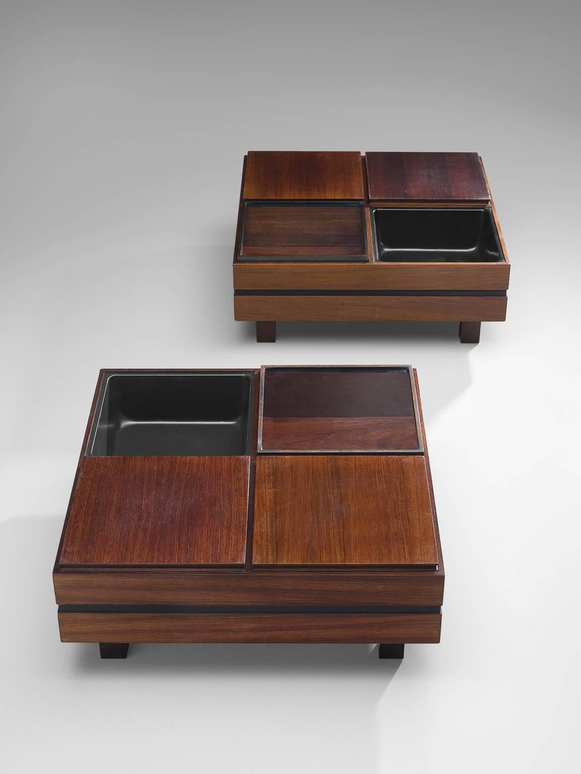 Produced by Sormani, pair of coffee tables, wood, glass, Italy, 1960s.

Architectural pair of side tables executed with four square elements each. The tables consist of a one empty element, one glass element and two wooden elements. The base of