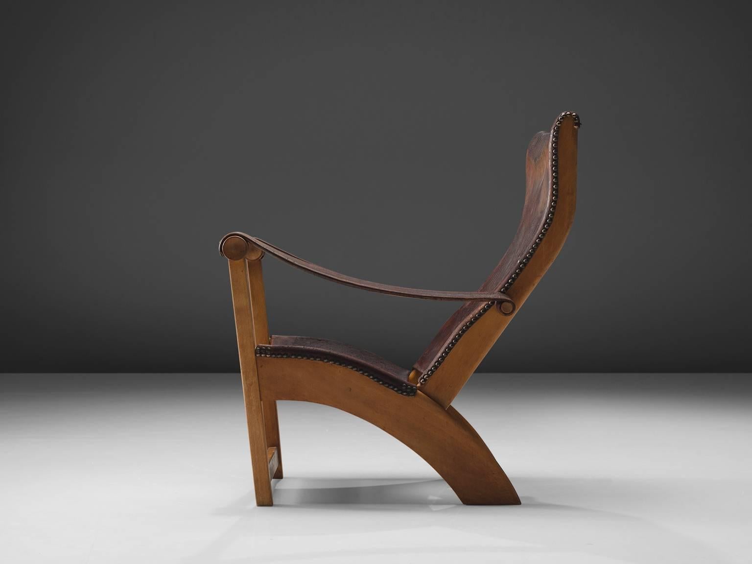 Mogens Voltelen for cabinetmaker Niels Vodder, lounge chair model 'Københavnerstolen', beech and brown leather, Denmark, 1936. 

This Copenhagen lounge chair is designed by Mogens Voltelen. Classic early edition in which the armrests are attached