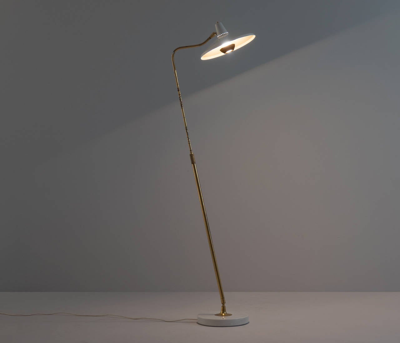 Giuseppe Ostuni for O-Luce, floor light model 301C, metal brass and stone, Italy, 1950s. 

A milestone was Ostuni's developments for O Luce regarding the telescopic extension what reflexes this days modern lighting design. It was applied to table,