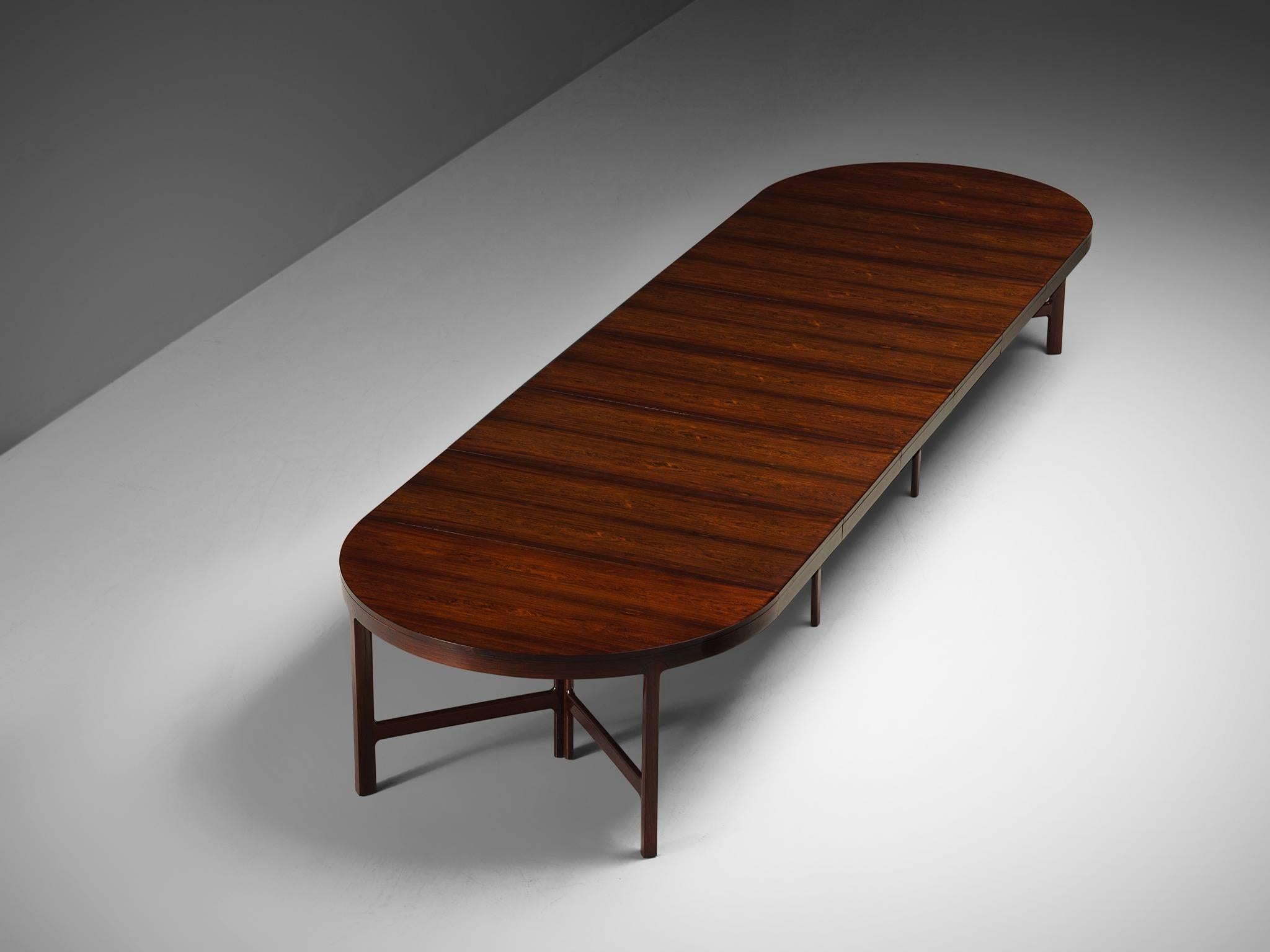 Danish cabinet maker, rosewood, Denmark, 1960s

Very large oval dining table with two tripod legs on each side and four legs in the middle. The grain of the rosewood and the exceptional length make this into a luxurious, probably custom made