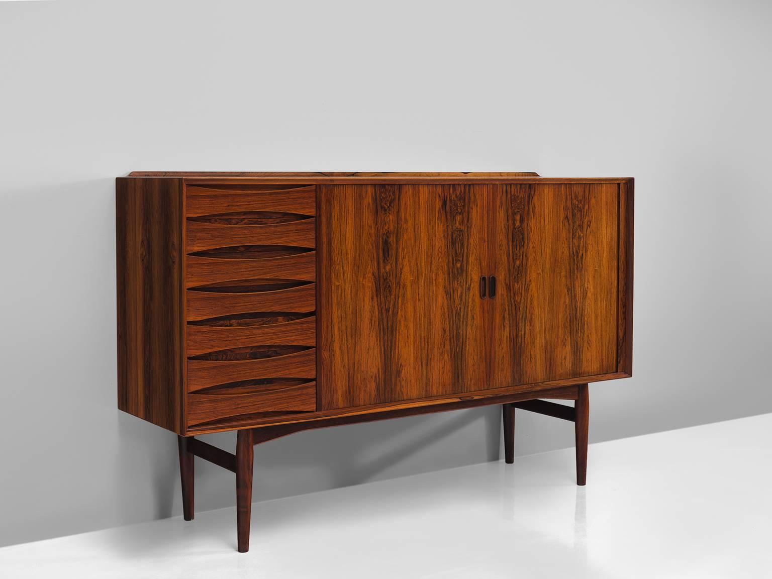 Arne Vodder for Sibast furniture, cabinet, rosewood, Denmark, 1960s.

This small rosewood sideboard is designed by Arne Vodder and is an iconic example of Danish midcentury furniture both in finish, aesthetics and use of material. The main